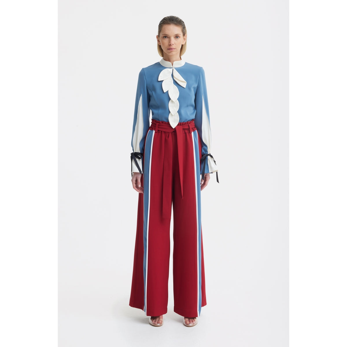 A woman stands against a white background wearing JULIA ALLERT's Belted High Waist Wide Leg Pants in burgundy.