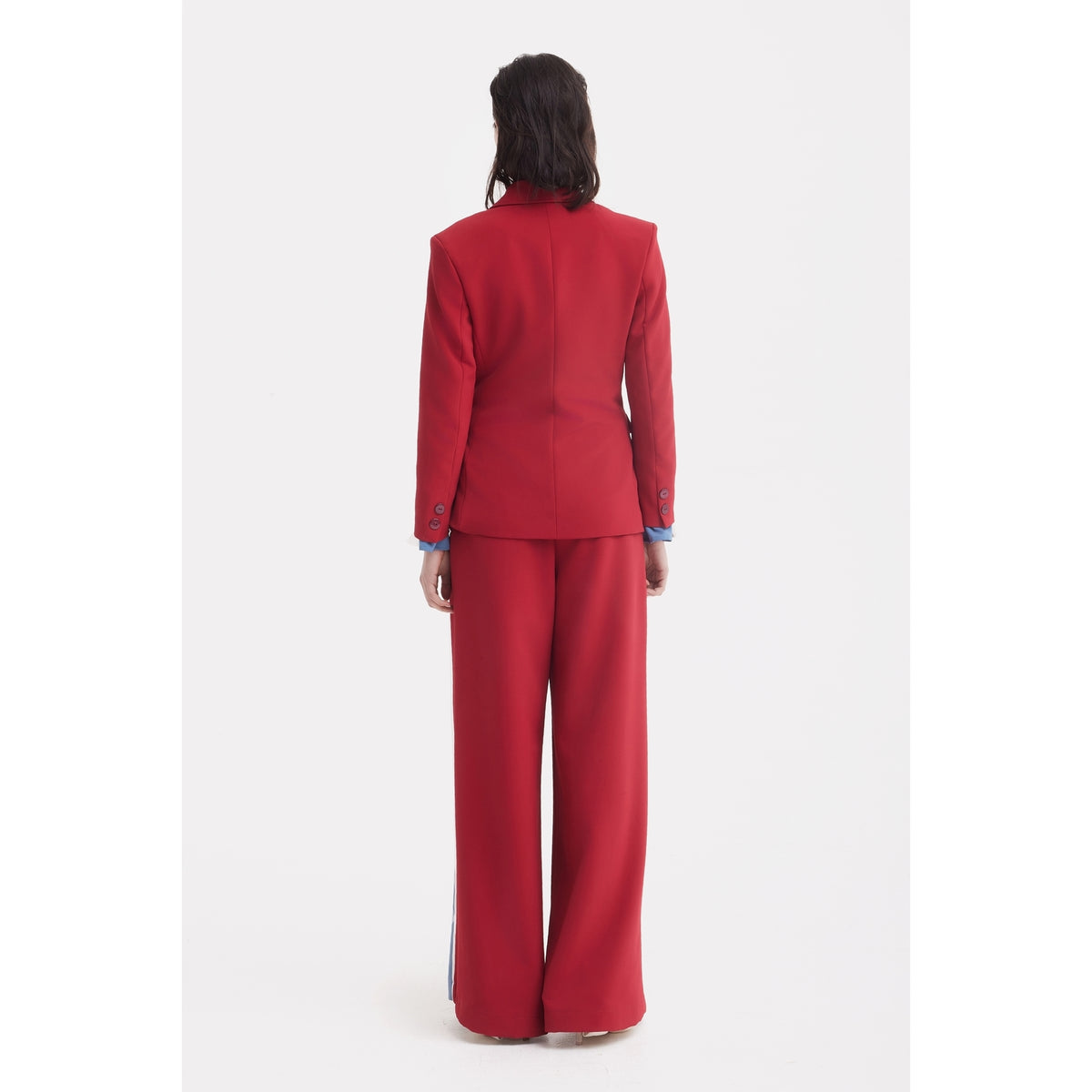 A person stands facing away against a plain white background, wearing burgundy Belted High Waist Wide Leg Pants by JULIA ALLERT and a fitted blazer. Their dark hair is shoulder-length.