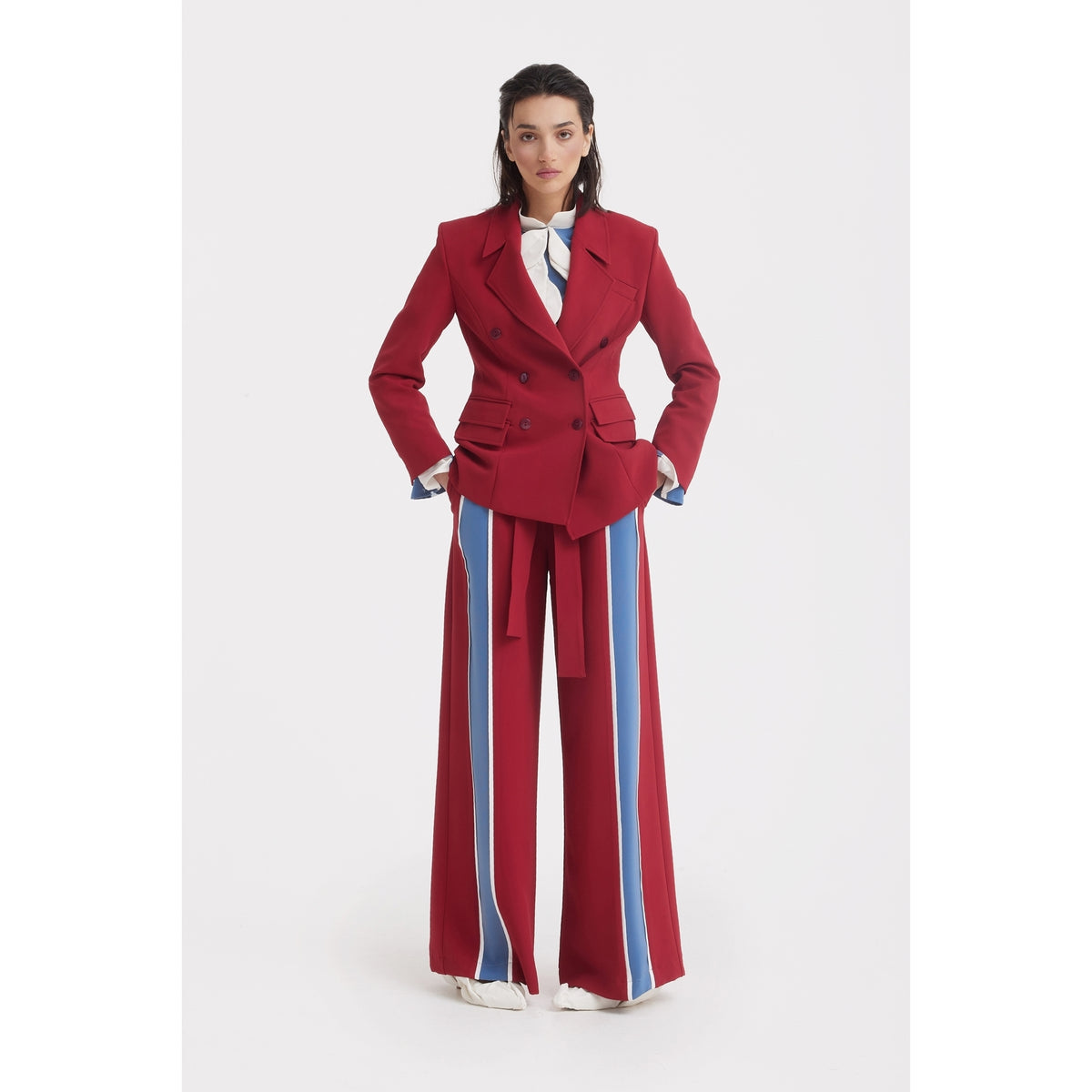 A woman stands facing forward in JULIA ALLERT's Belted High Waist Wide Leg Pants in burgundy, paired with a matching tailored double-breasted blazer, against a plain white background.