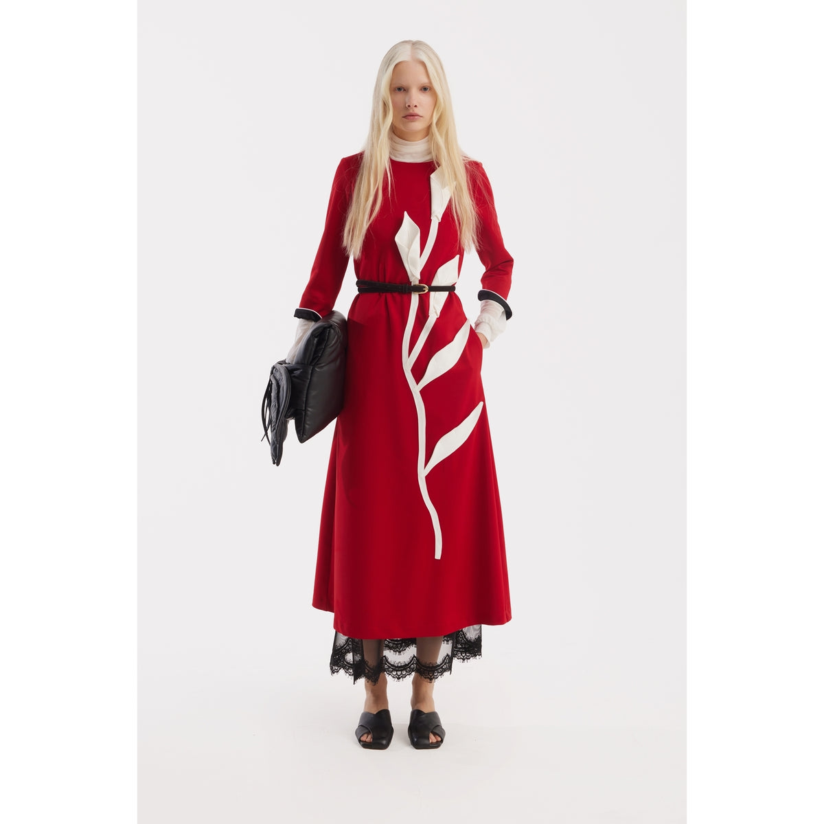 A woman with long blonde hair wears the JULIA ALLERT Art-Inspired Semi-Fitted Three-Quarter Sleeves Dress in red, paired with black heels, a black belt, and a black clutch. She stands against a plain white background.