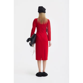 A woman faces away, wearing a JULIA ALLERT Solid Formal Midi Dress - Red, black slippers, and a black hat. She holds a black jacket over her left arm against a plain white background.