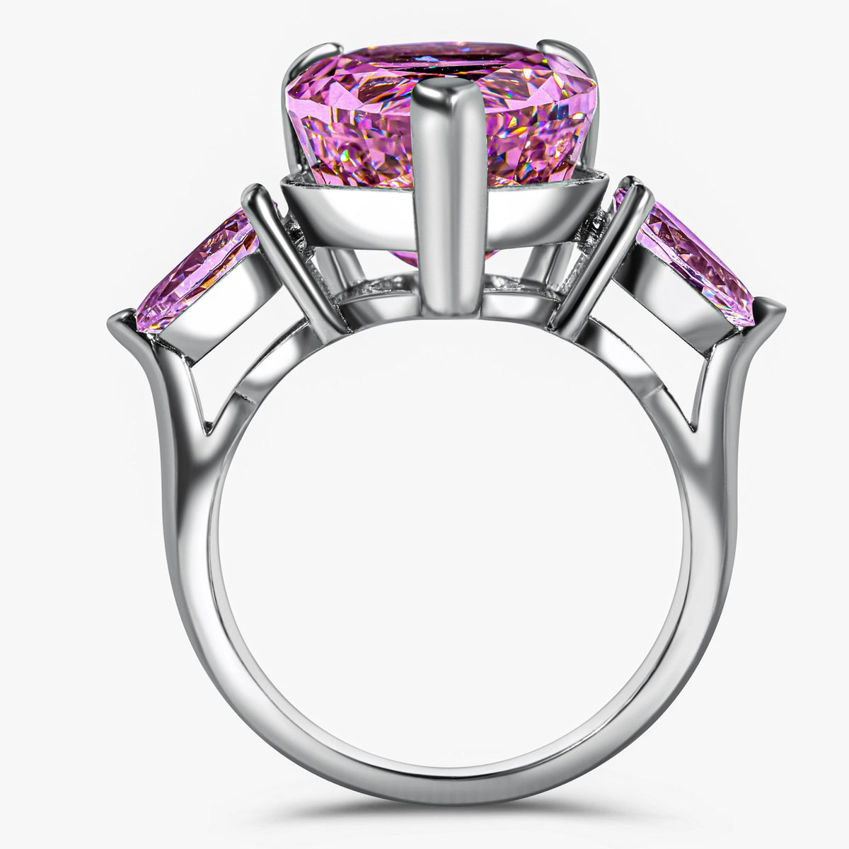 Silver ring with pink gemstones on a white background