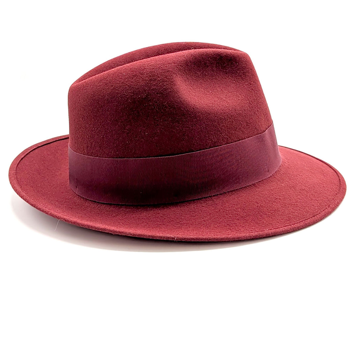 Red fedora hat with a wide brim on a white background