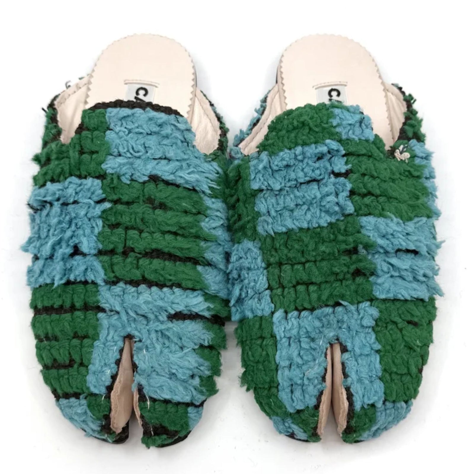 Pair of green and blue slippers on a white background