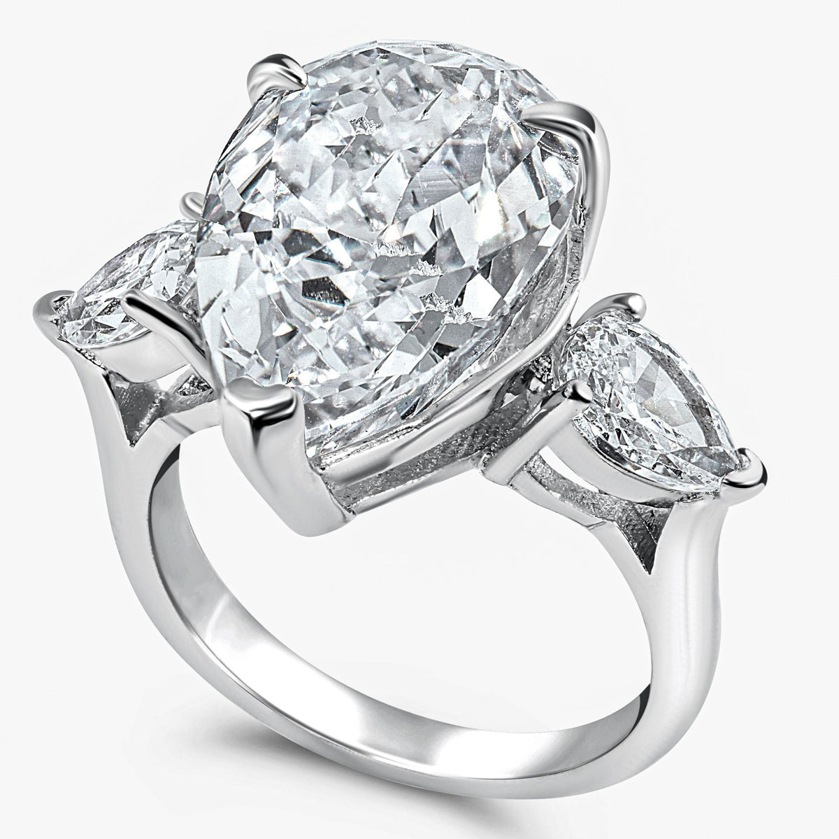 Diamond ring with a pear-shaped center stone and two smaller stones on a white background