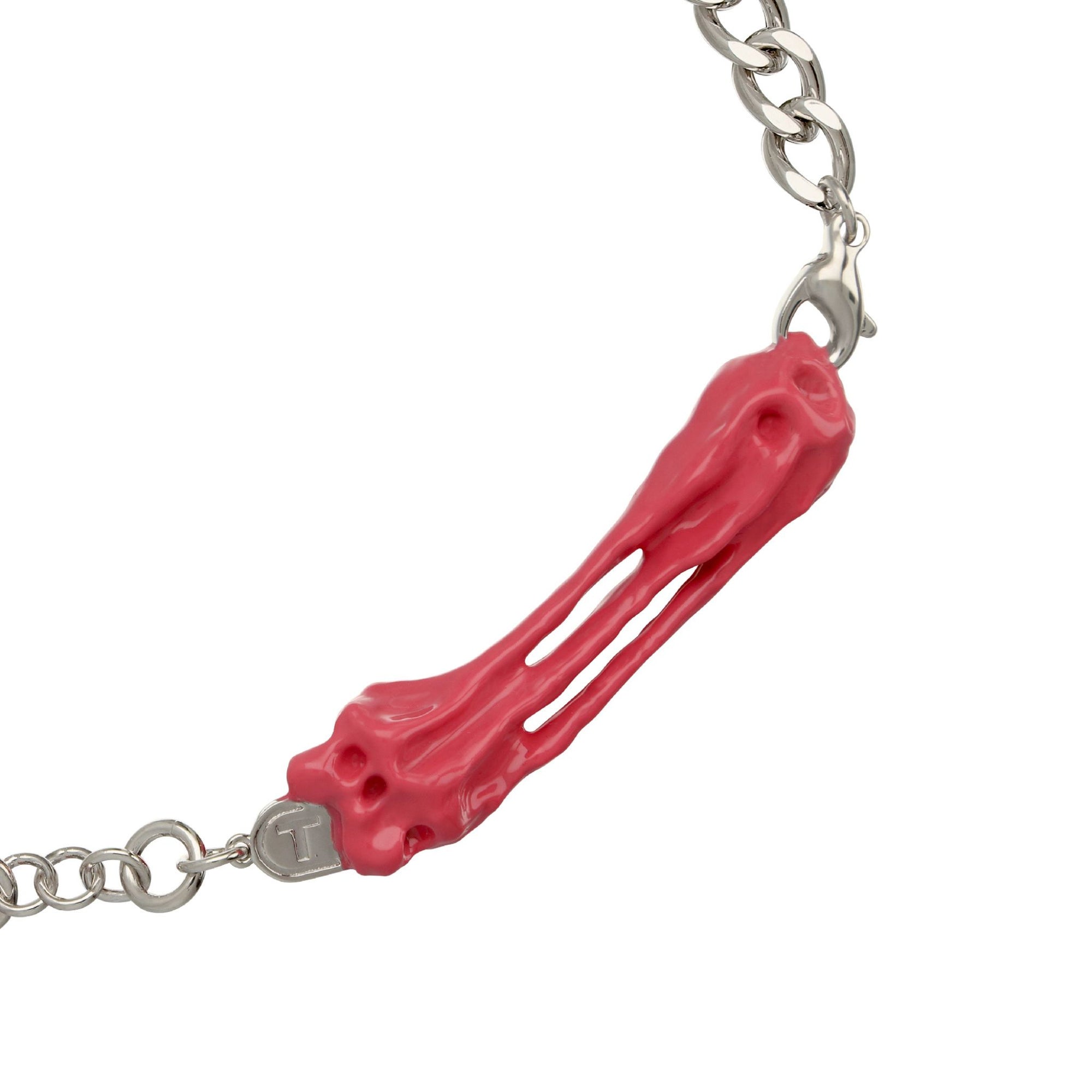 Bracelet with a pink coral-like charm on a white background