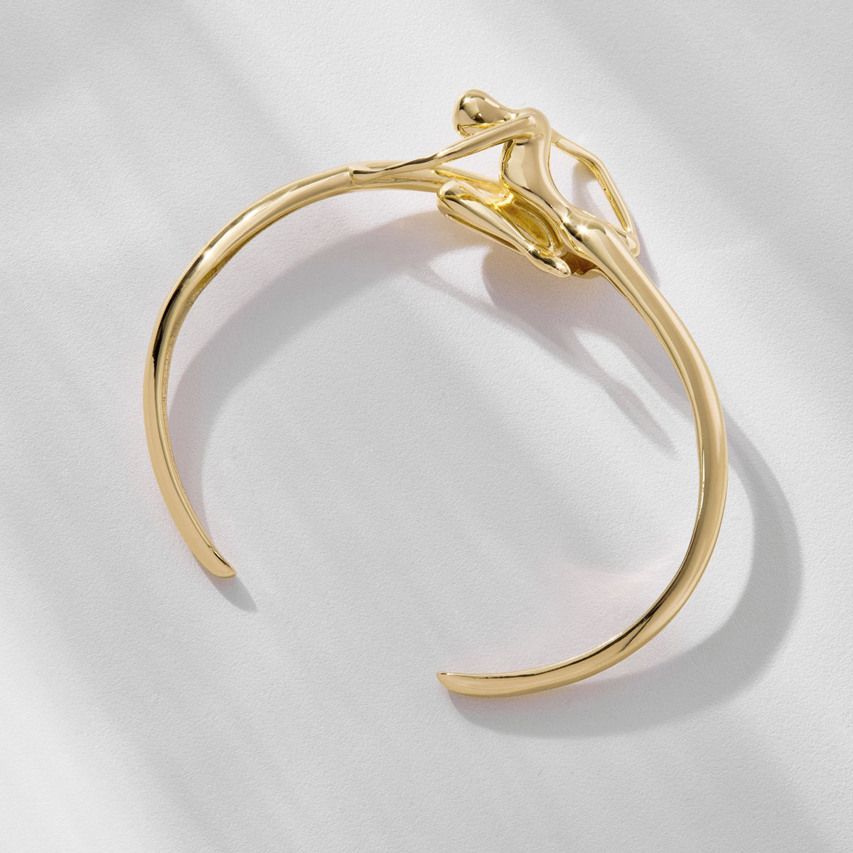 The Gold Instinto Bracelet from ANNA PRATA’s Corpo E Alma Collection features a minimalist, abstract human figure design—an elegant women’s bracelet that redefines subtle sophistication with its artful form.