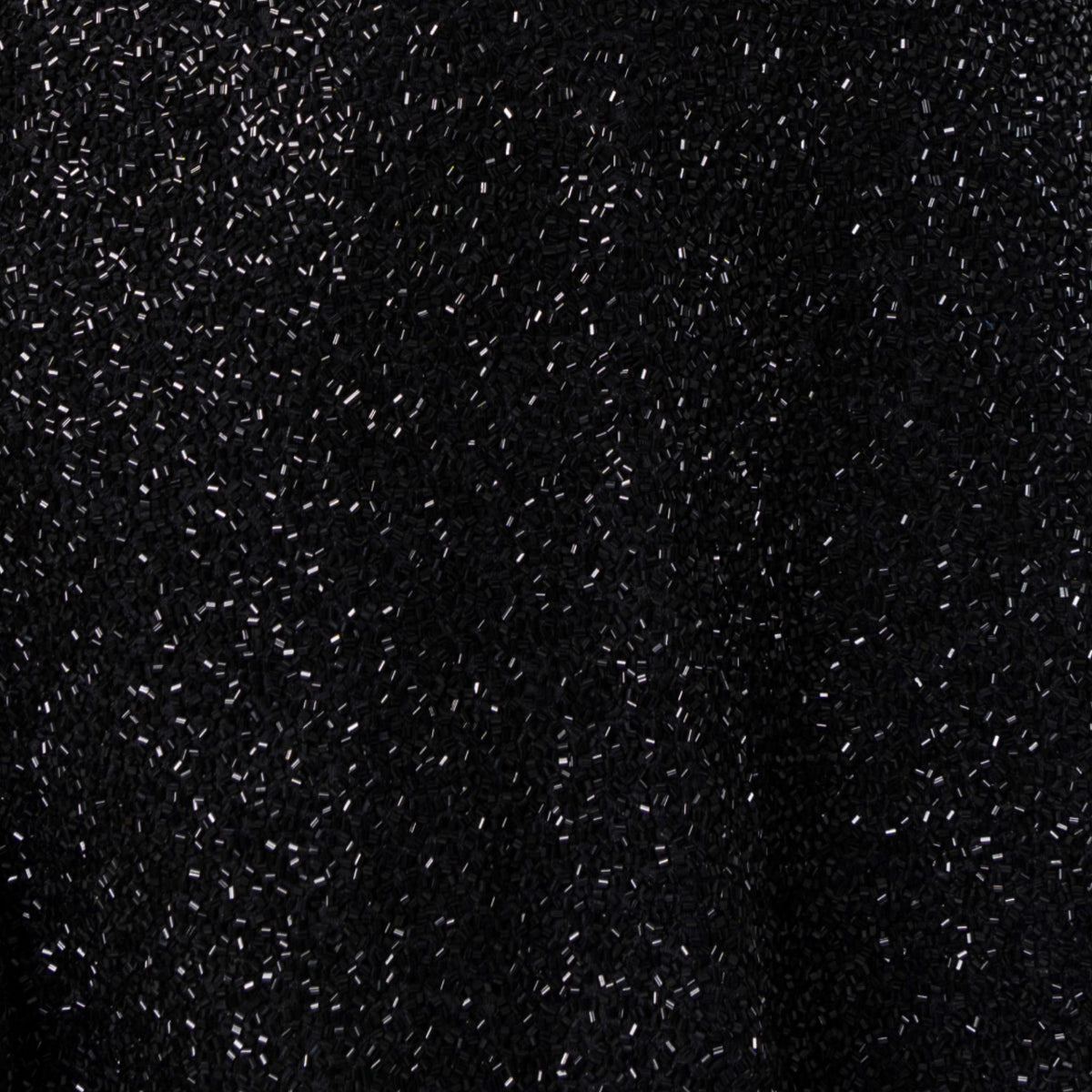 Close-up of SELF-ADORE's Midnight Hand-Beaded Embellished Mini Dress, showcasing textured black fabric adorned with countless sparkling silver beads for a shimmering effect.