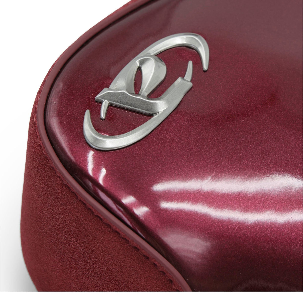 Close-up of a maroon bag with a silver logo on a white background