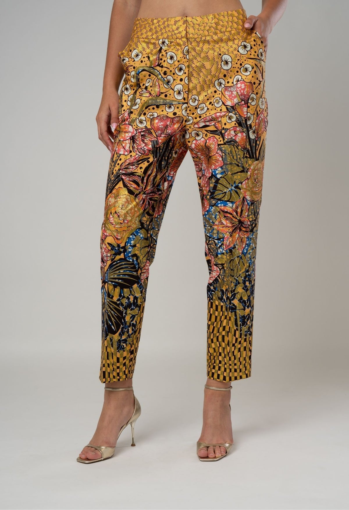 Floral and butterfly patterned pants on a plain background