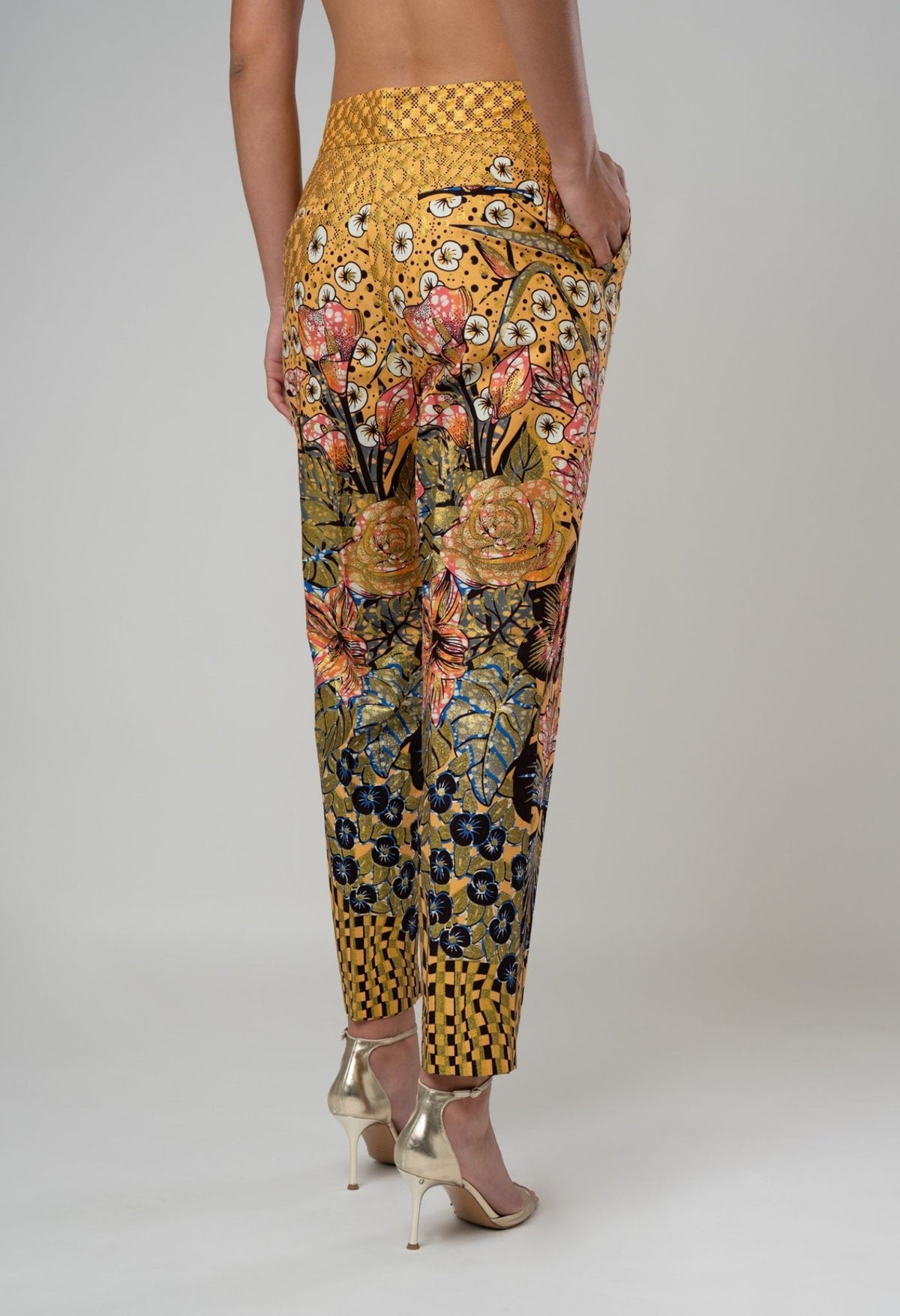 Floral and geometric patterned pants on a plain background