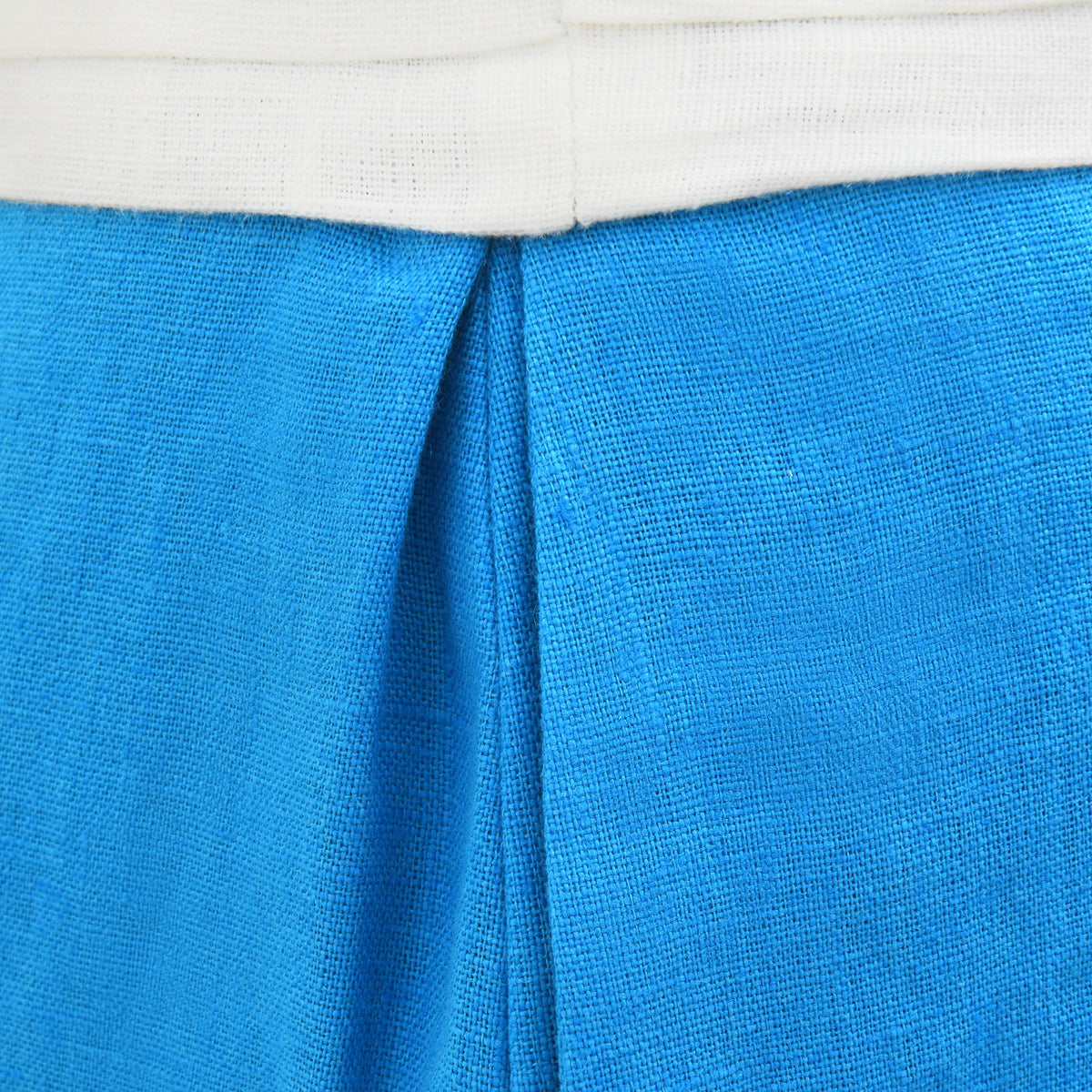 Close-up of white religious folds detail on waistband and hem