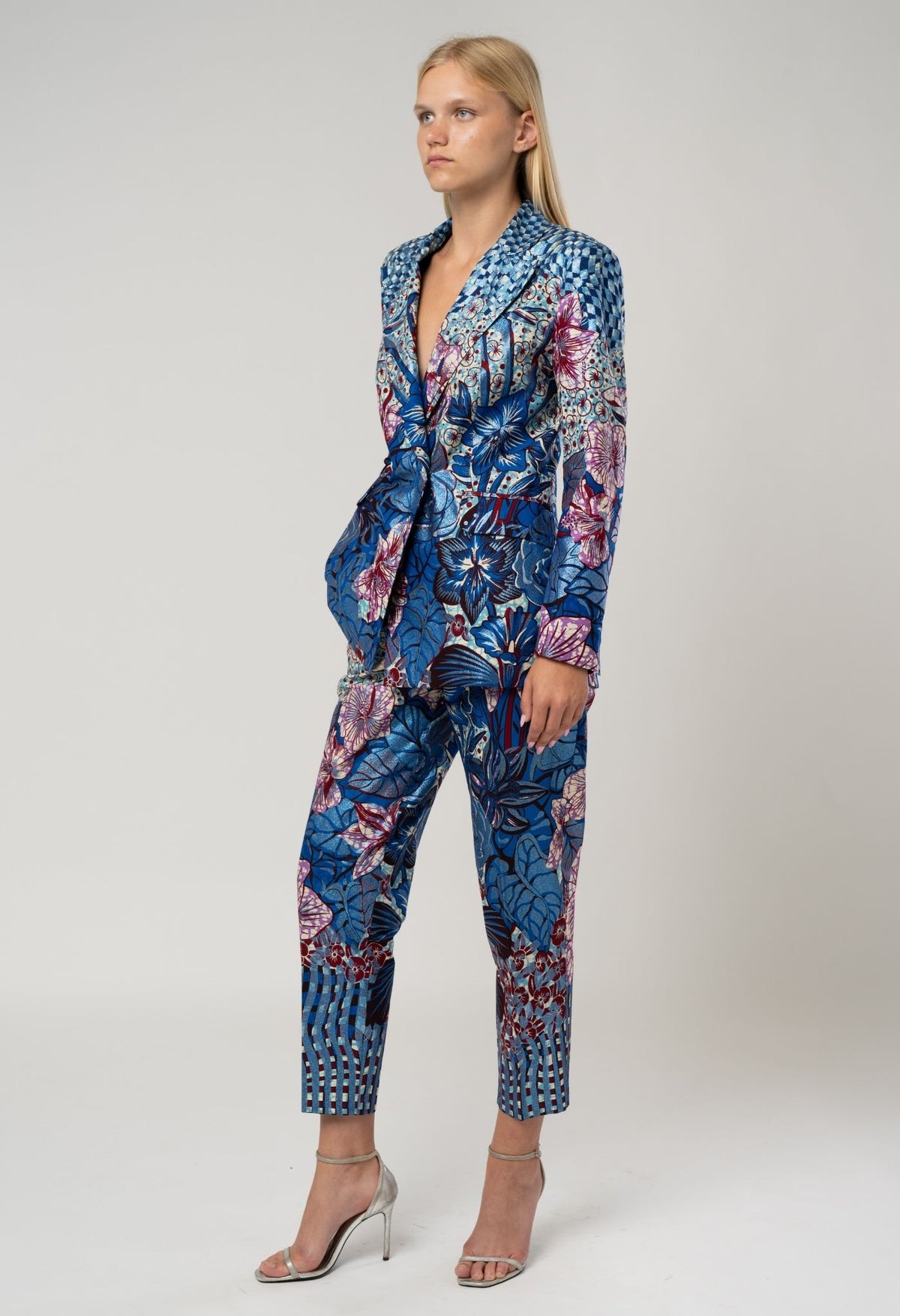 Woman wearing a blue floral patterned suit on a white background