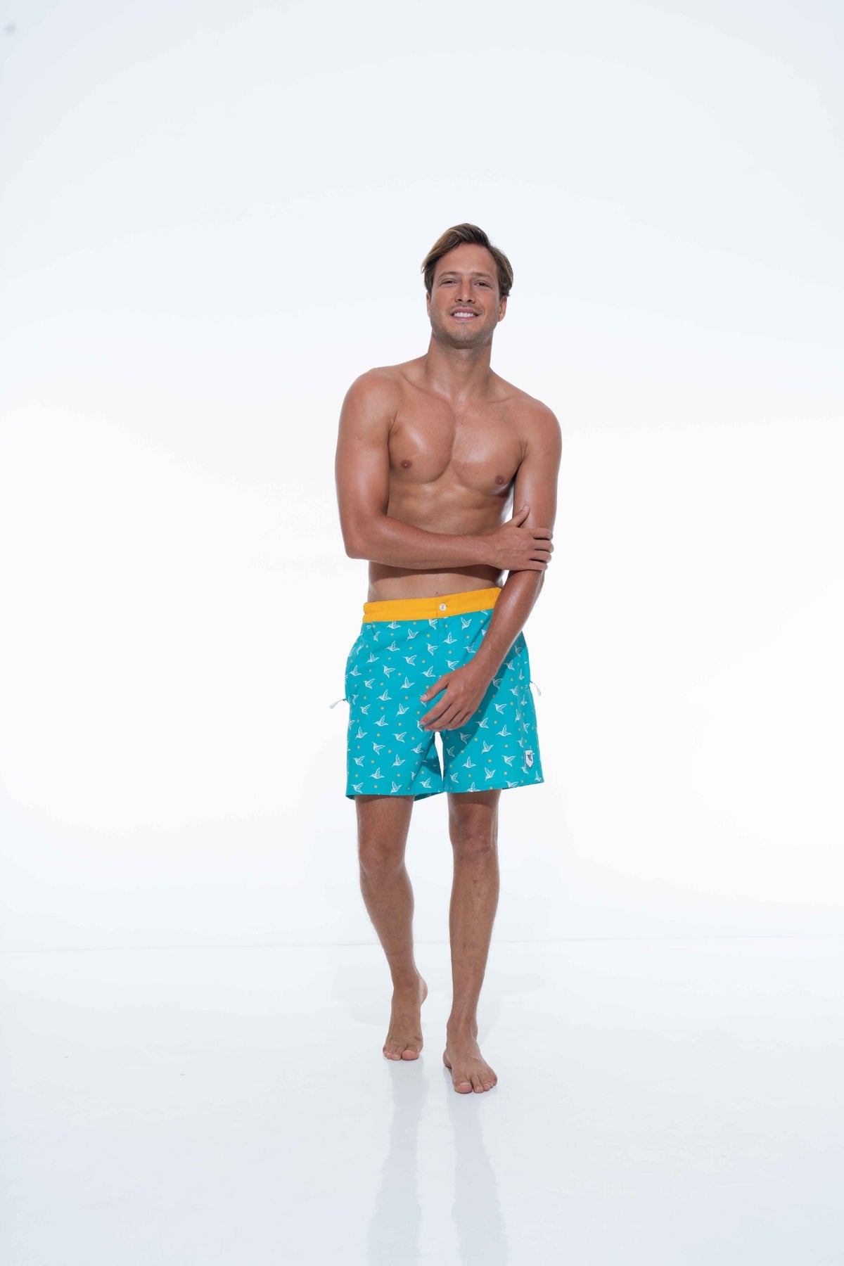 Model wearing Aquamarine monogram swim trunks