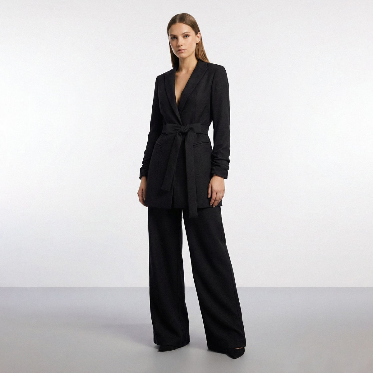 Woman wearing a black suit on a white background