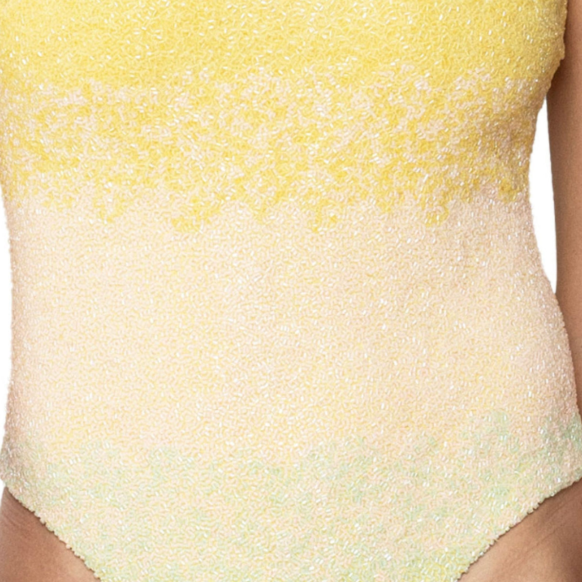 Close-up of a person wearing the SELF-ADORE Ombre Hand-Beaded Embellished One-Piece Swimsuit in yellow. This sleeveless, gradient-patterned resortwear is perfect for sunny days, shown against a white background with partially visible arms.