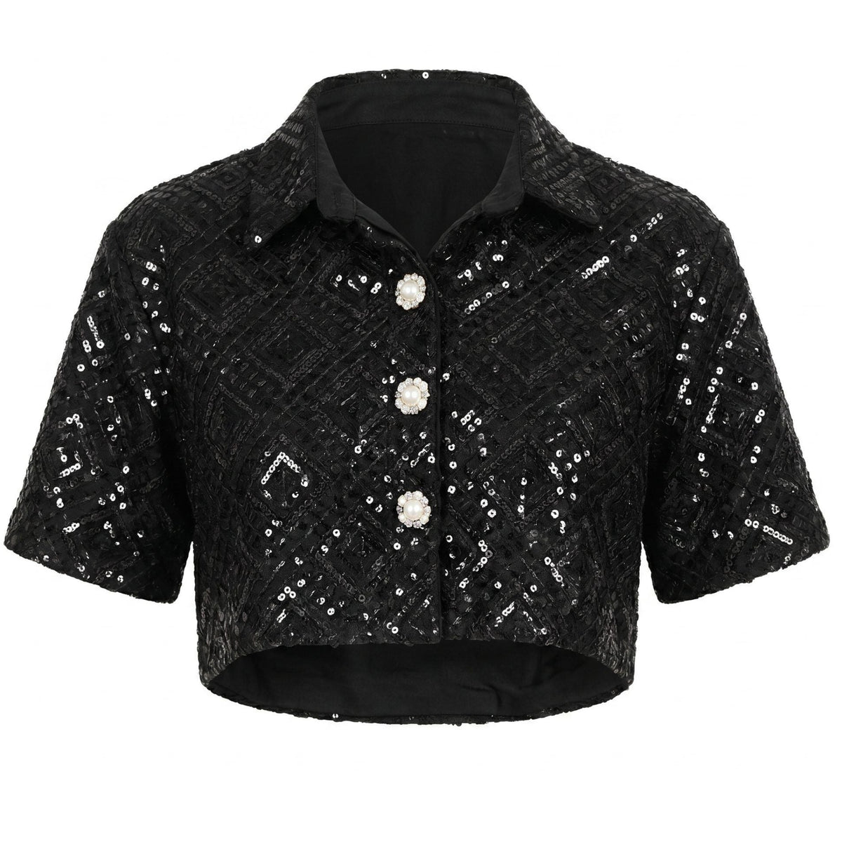 The Sequin Co-Ord Crop Shirt by INTERNATIONAL APPEAL is a black, short-sleeve, cropped blouse with a collared neckline, geometric sequin embellishments, and pearl-like buttons—part of their limited edition fashion collection.