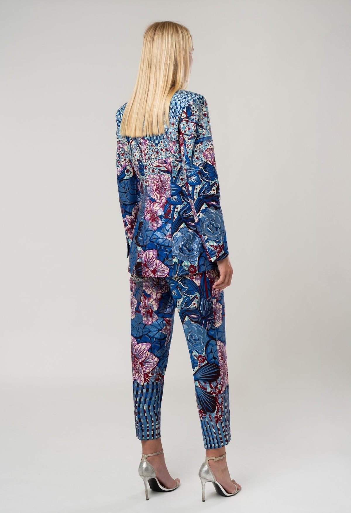 Woman wearing a blue floral patterned suit on a white background