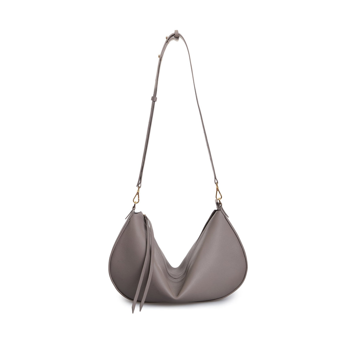 The Denise Bag by VIKELE STUDIO is a gray, crescent-shaped luxury handbag with a long adjustable strap, gold hardware, and dual zipper pulls, shown against a white background.