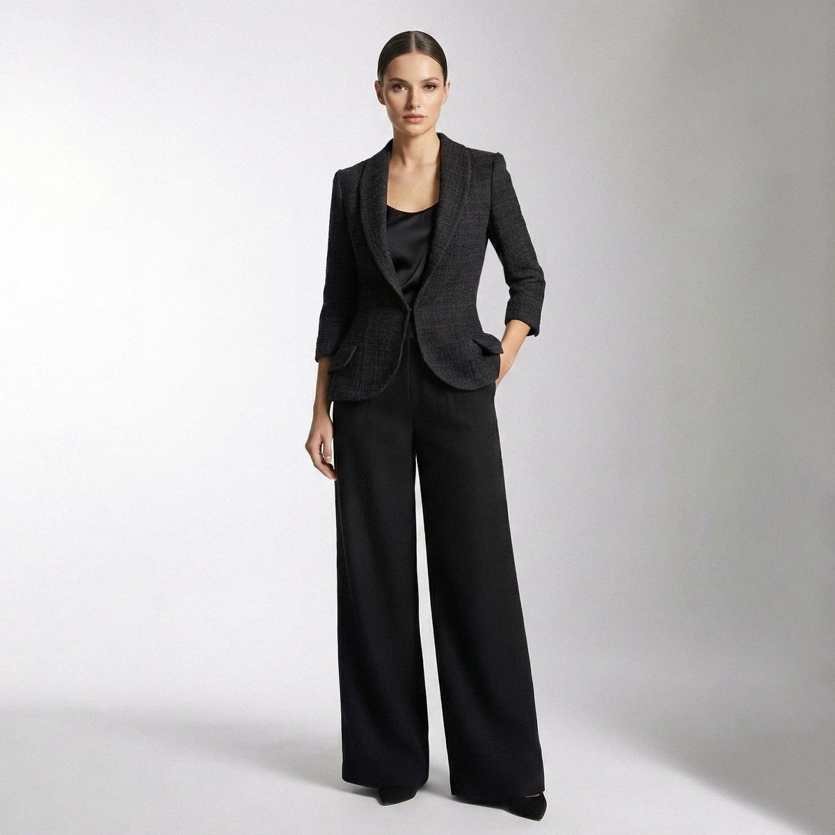 Woman wearing a black suit on a white background