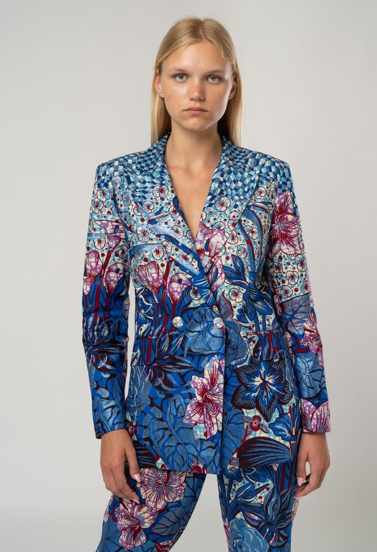 Woman wearing a blue floral patterned suit on a white background