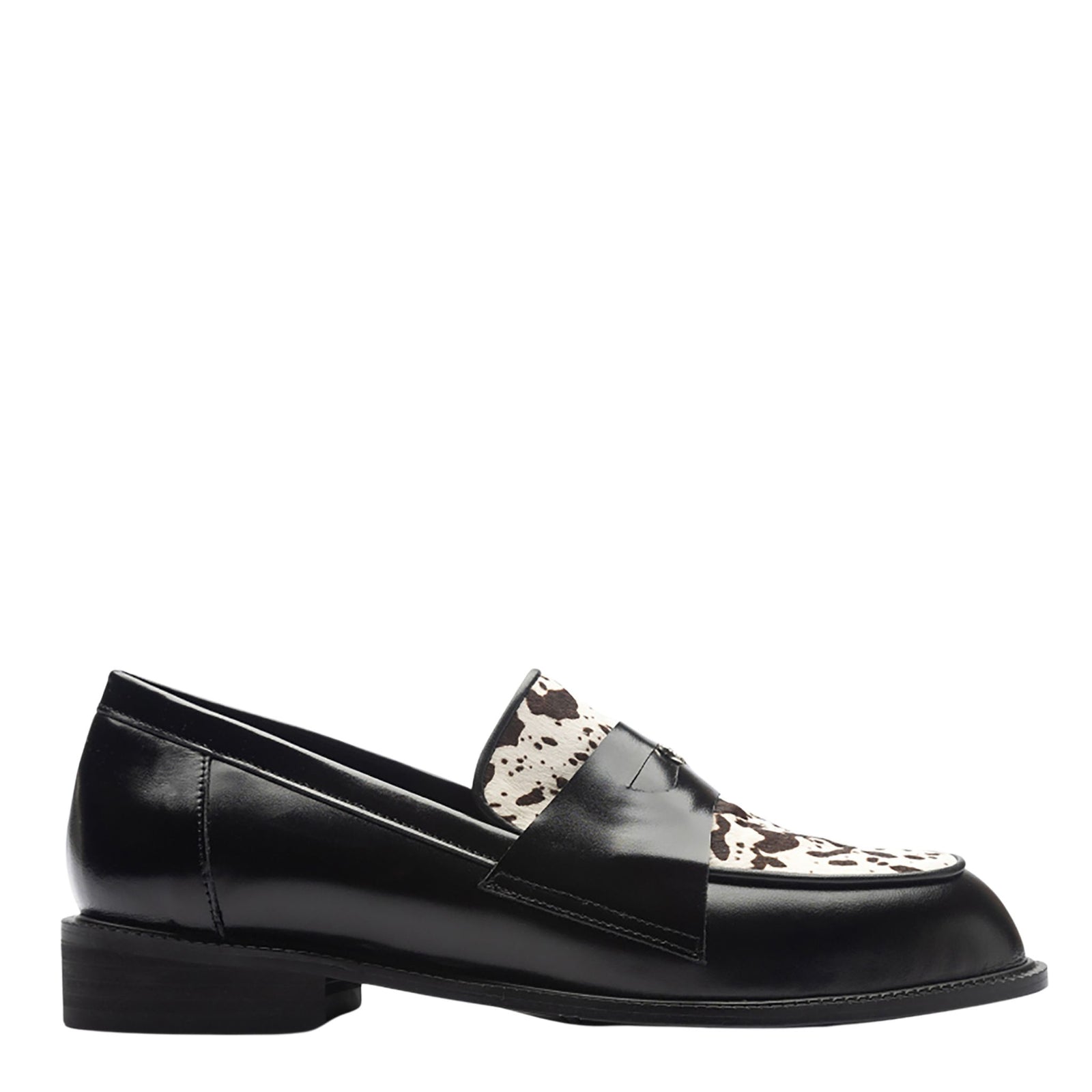 The THEN Black Leather Loafers with Cowhide Print Vamp are handmade in Korea, featuring a low heel and eye-catching cowhide-print vamp, shown in a side view against a white background.