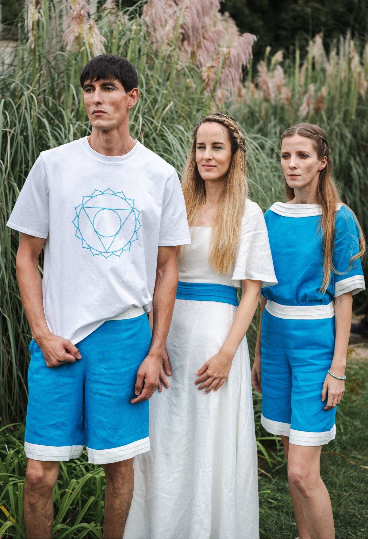 Model wearing turquoise linen top with white trim and short sleeves