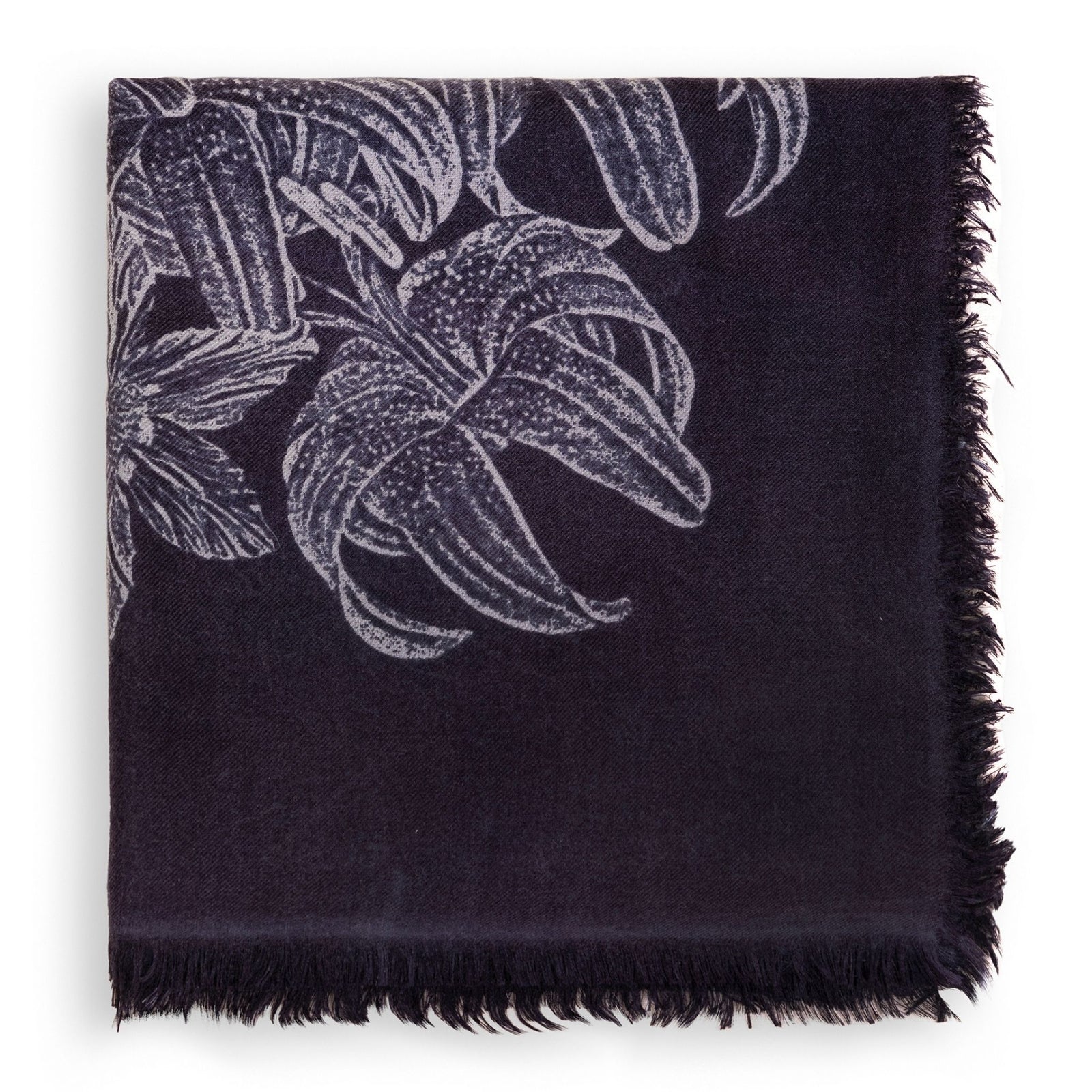 The OO-TO Black Printed Eden Square Scarf, featuring white floral patterns and fringed edges, is handcrafted in Nepal and displayed against a white background.