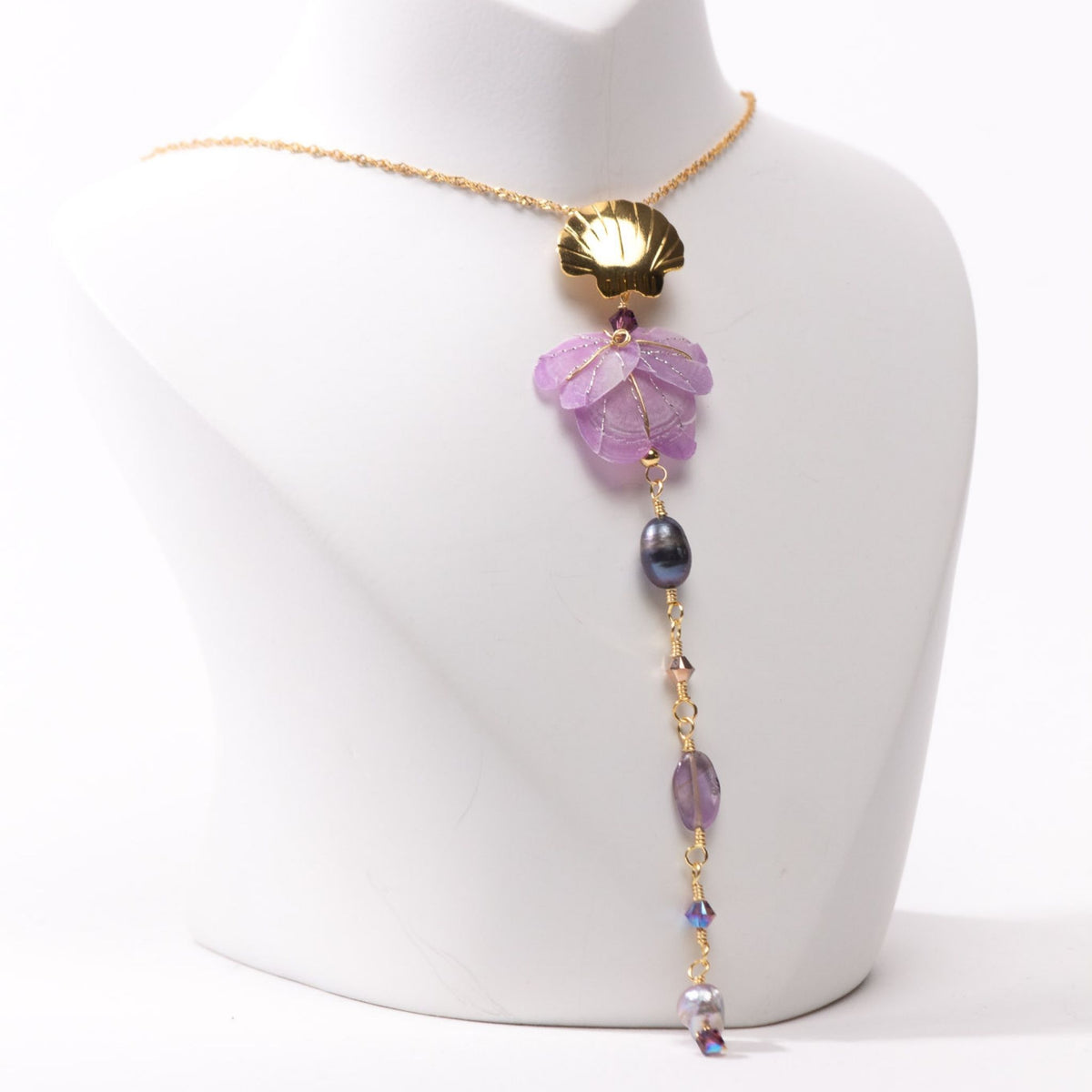 Model chest wearing neckalace in close up