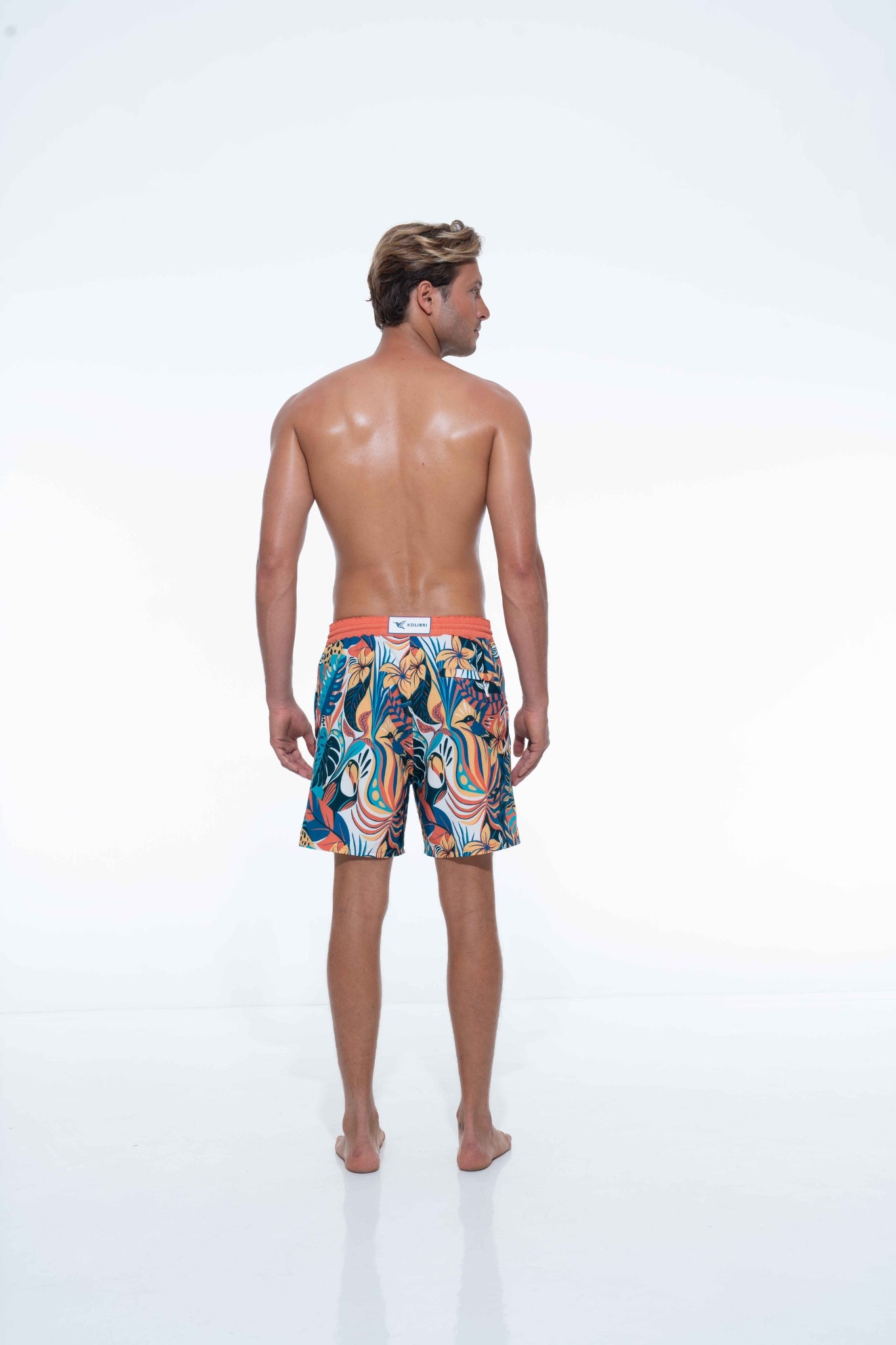 Model wearing eco-friendly jungle print swim shorts