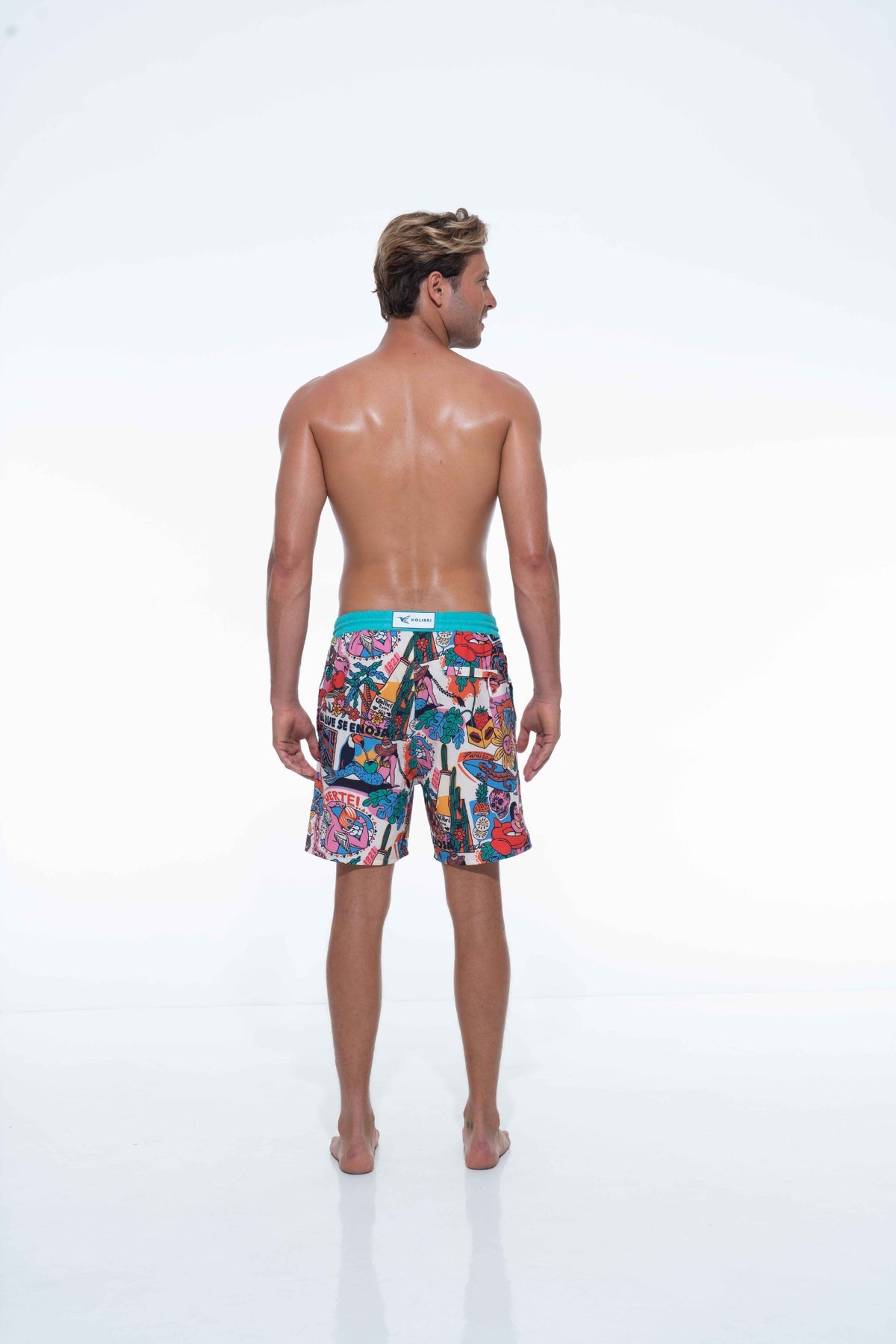 Model wearing bold Fuerte print swim shorts