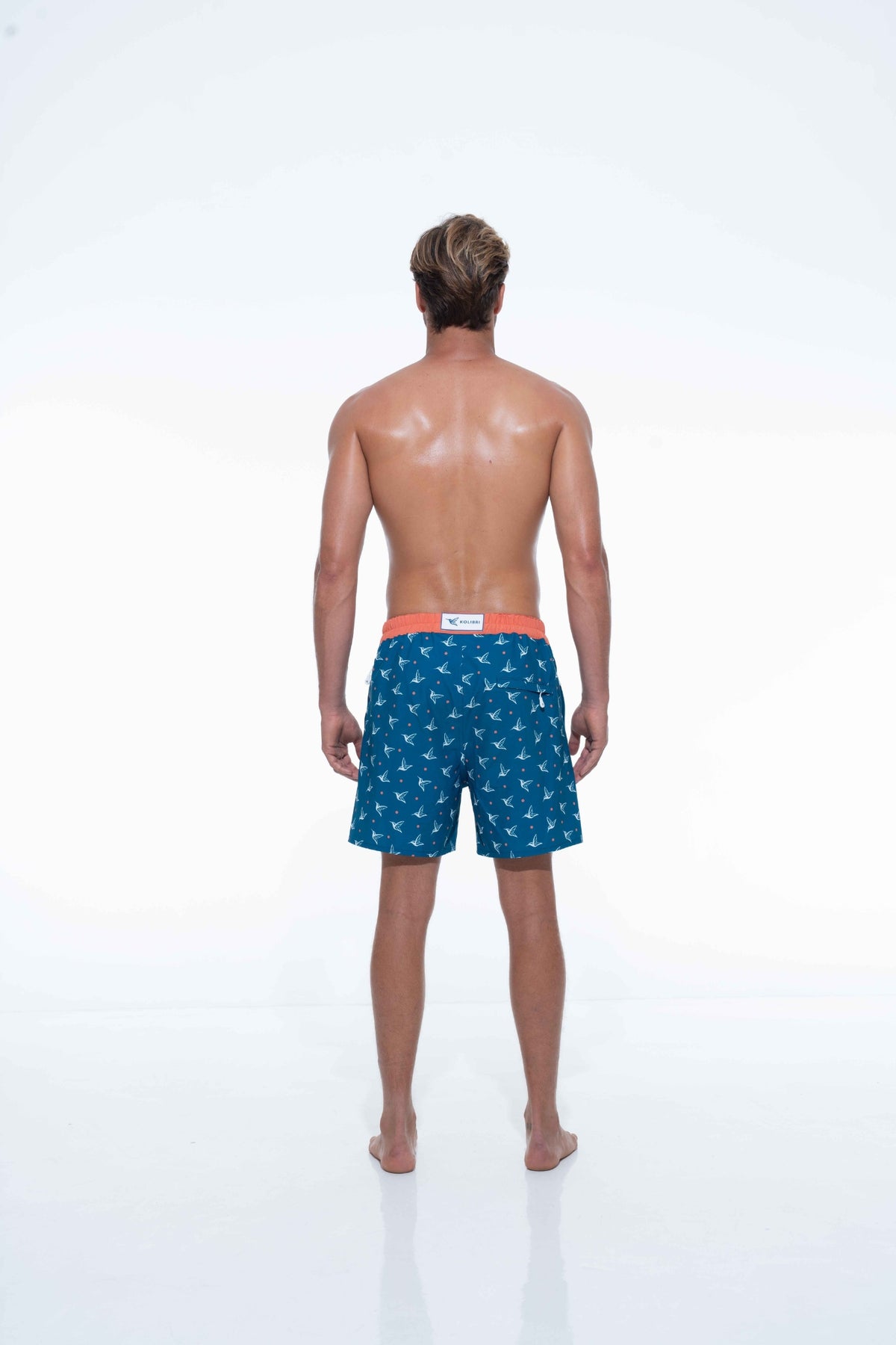 Model wearing Deep Ocean monogram swim trunks