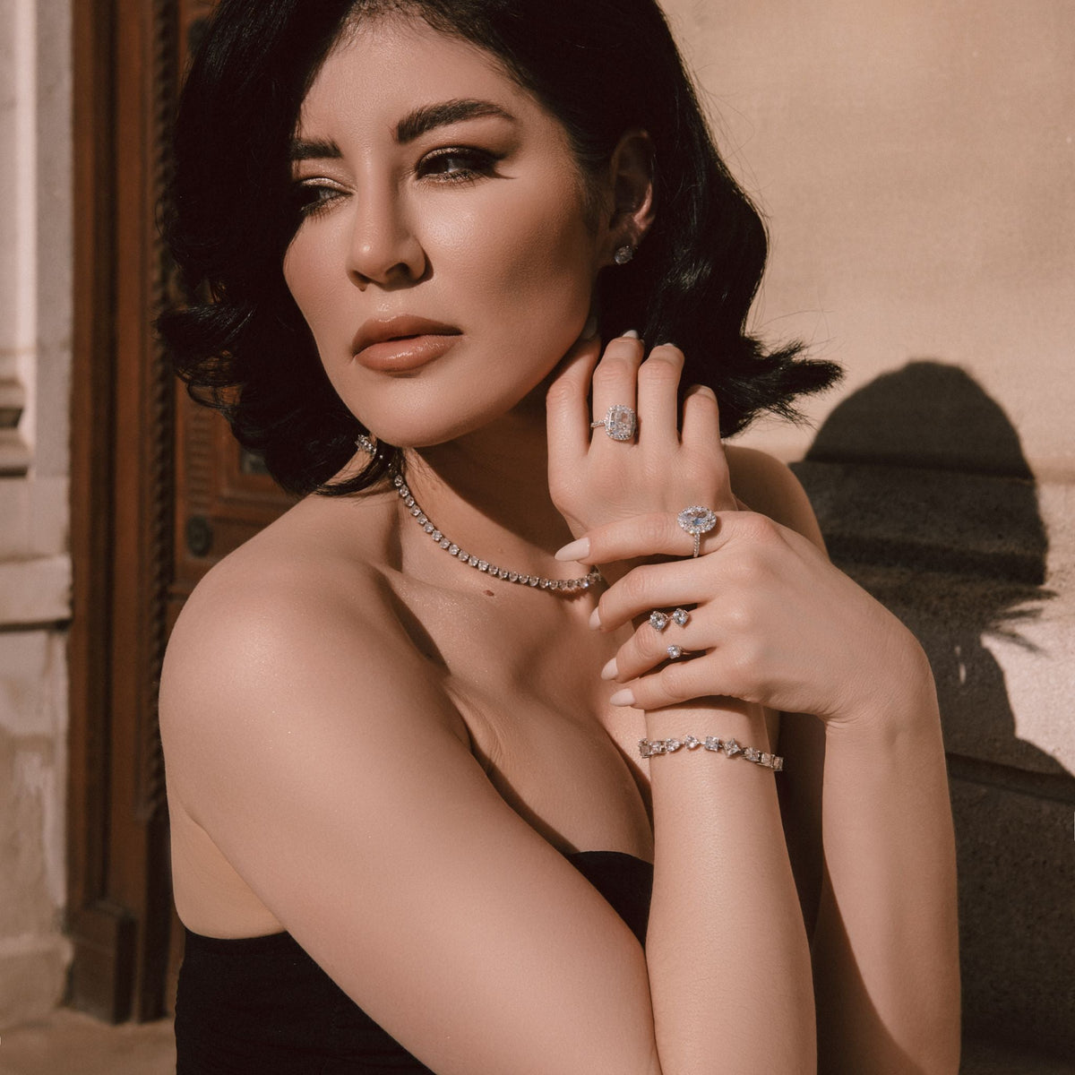 Woman wearing jewelry with a neutral background