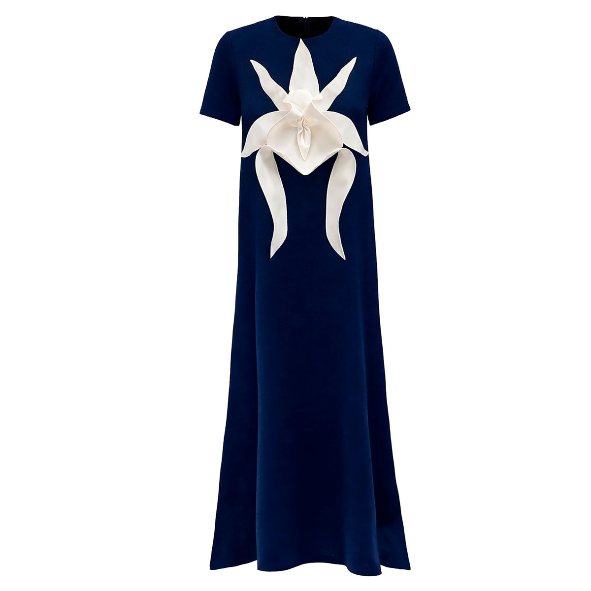 The JULIA ALLERT Ankle-Length Knit Dress With Flower Detail in dark blue features short sleeves and a striking white sculptural floral appliqué on the chest.