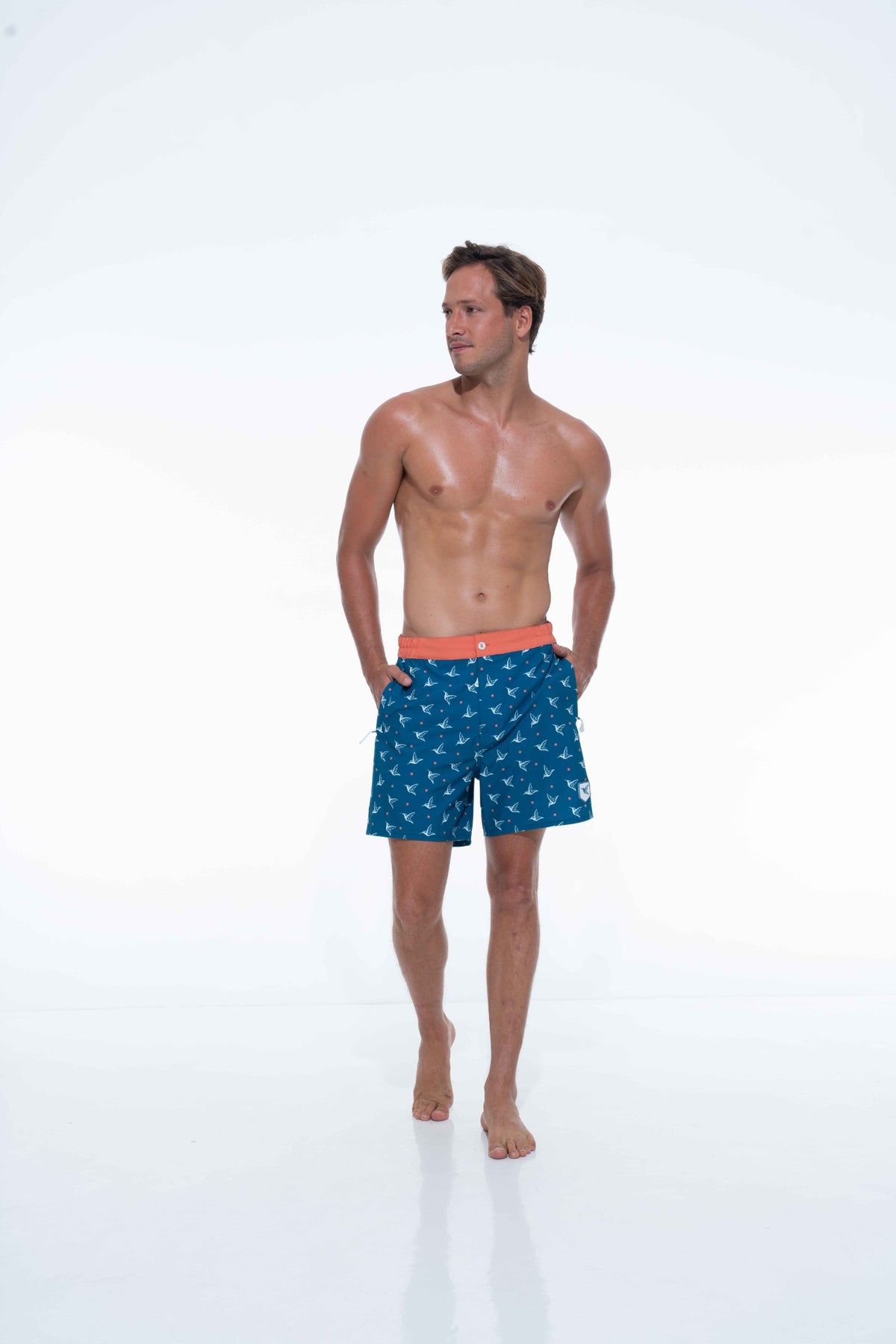 Model wearing Deep Ocean monogram swim trunks