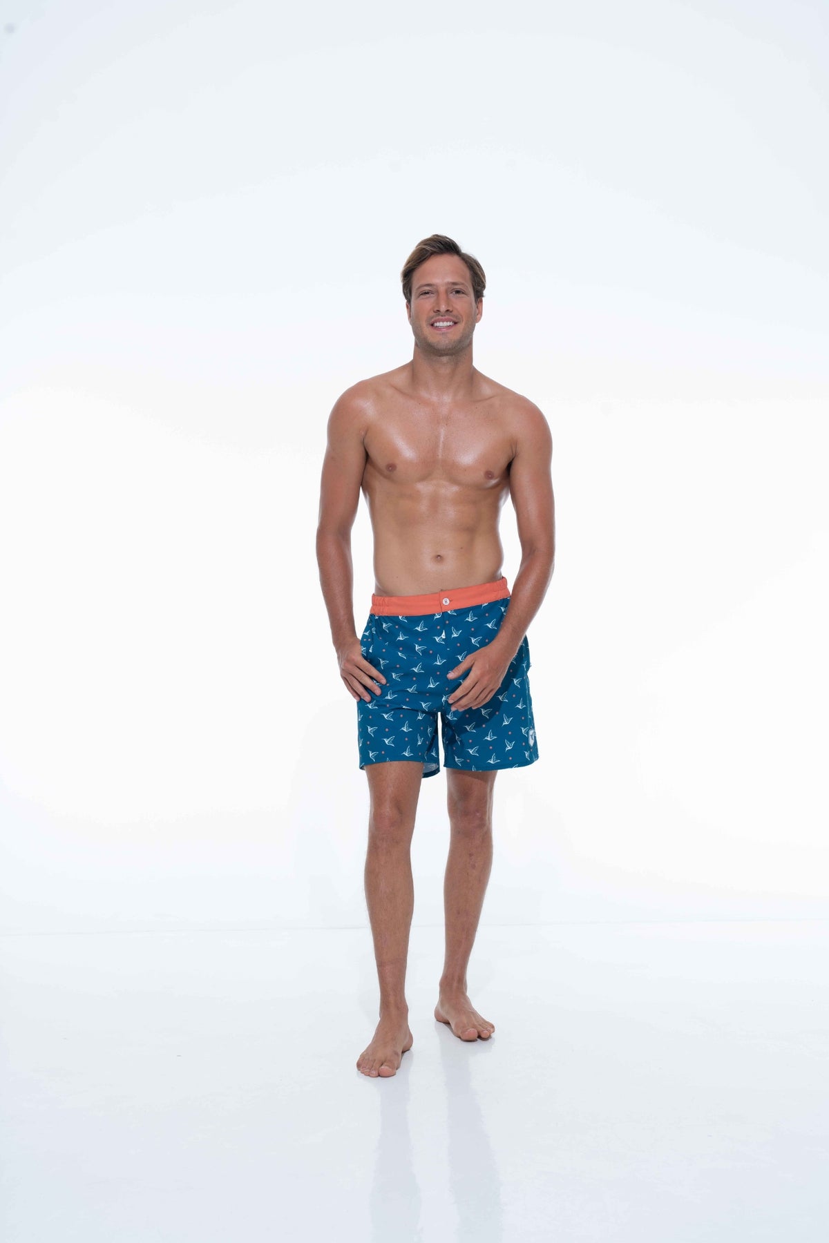Model wearing Deep Ocean monogram swim trunks