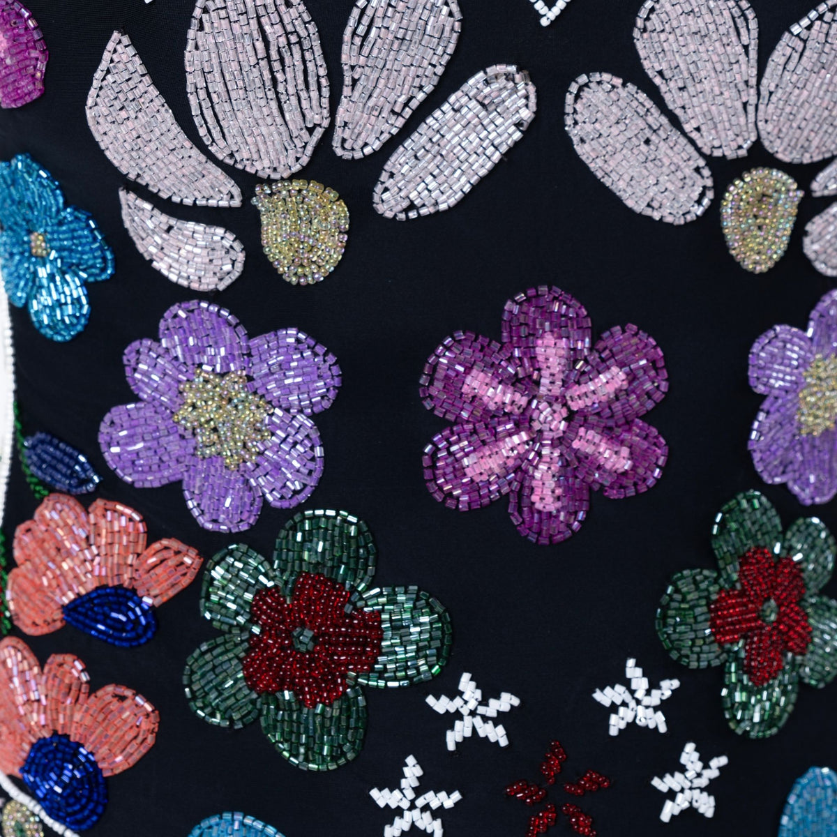 The SELF-ADORE Flower Hand-Beaded Embellished One-Piece Swimsuit features colorful floral beads and sequins embroidered on black fabric, with pink, purple, green, blue, and red accents for a vibrant look.