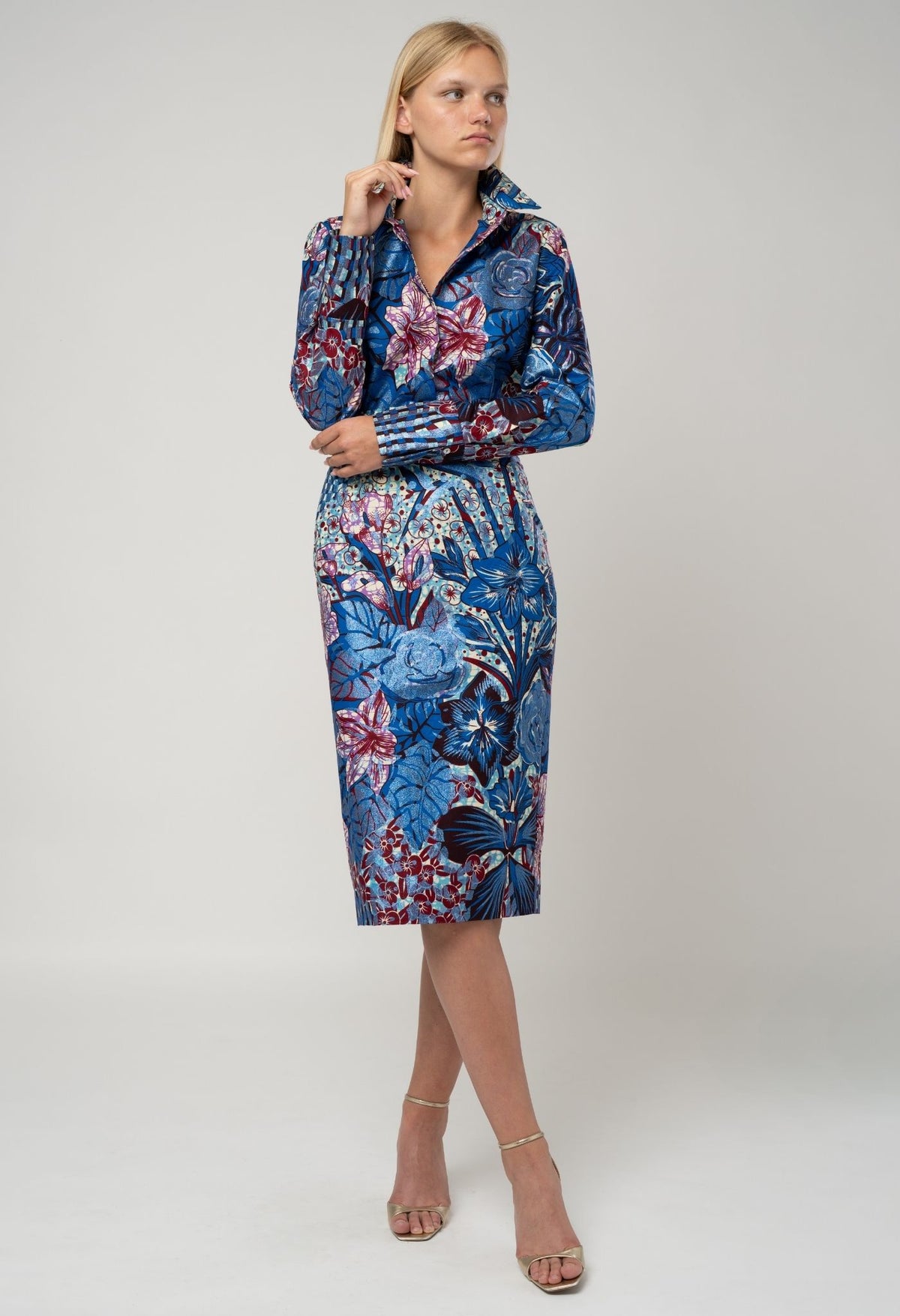 Woman wearing a blue floral dress on a white background