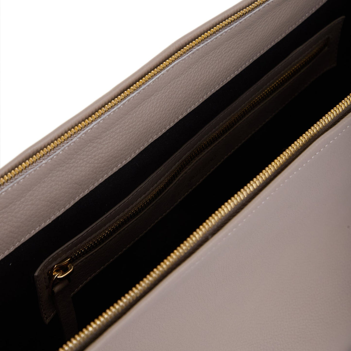Close-up of the Denise Bag | Gray by VIKELE STUDIO, highlighting its gold zipper, fabric-lined compartment, and inner zippered pocket against a black background.