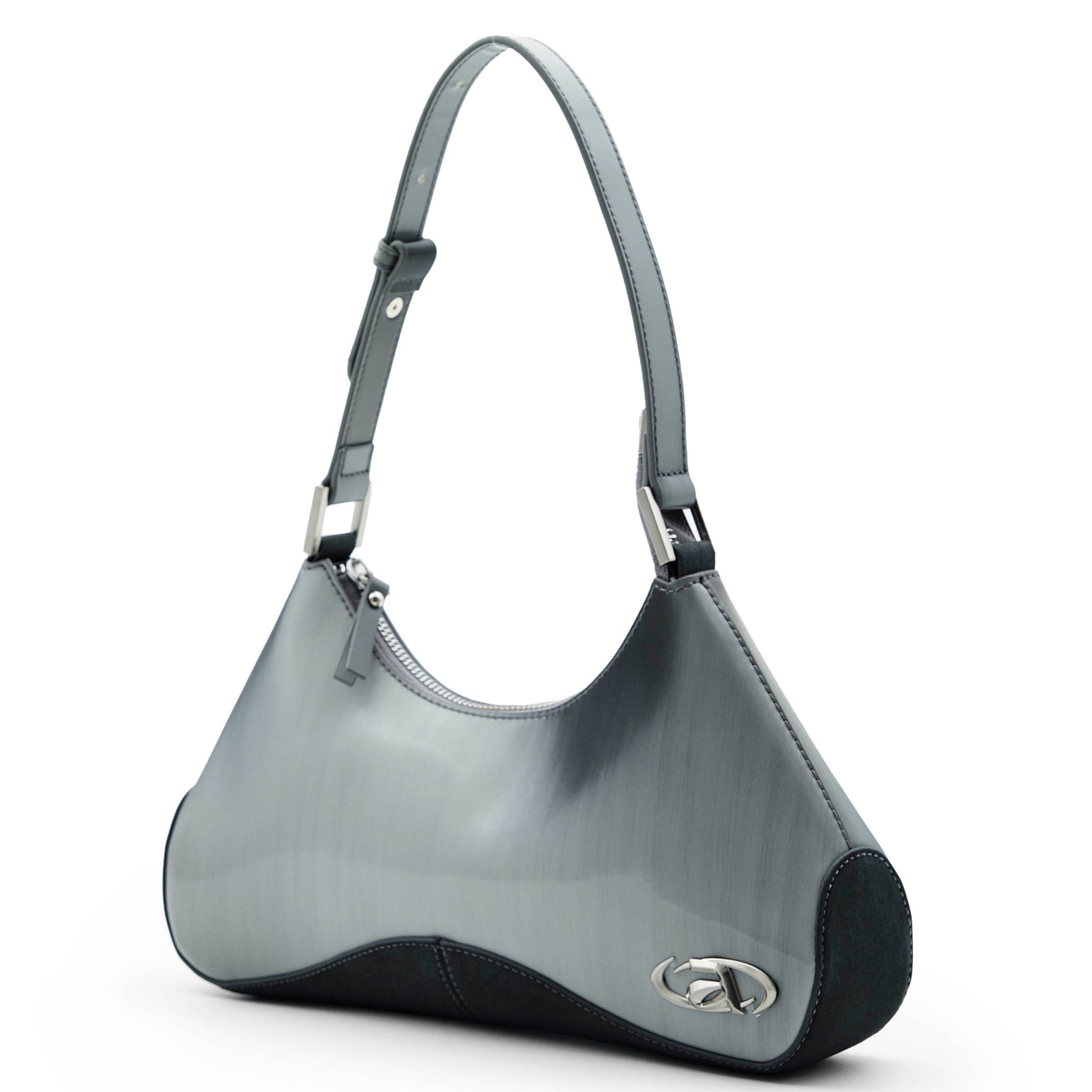 Close-up of Ada crossbody bag with signature metal logo and top zip closure