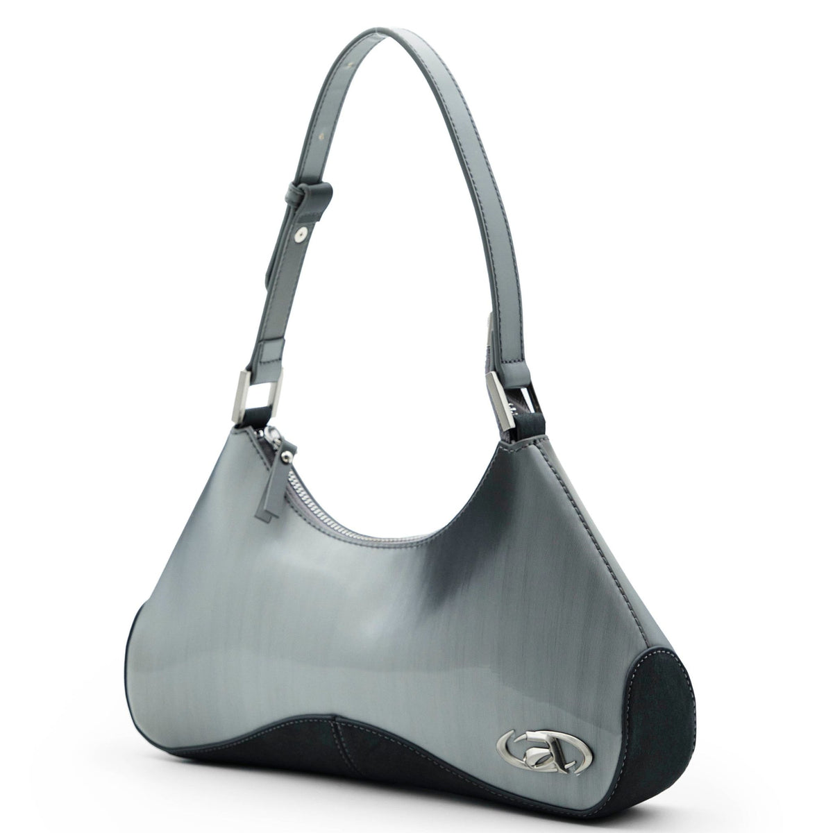 Close-up of Ada crossbody bag with signature metal logo and top zip closure