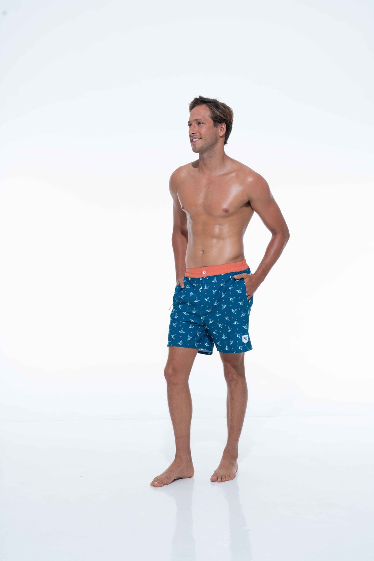 Model wearing Deep Ocean monogram swim trunks