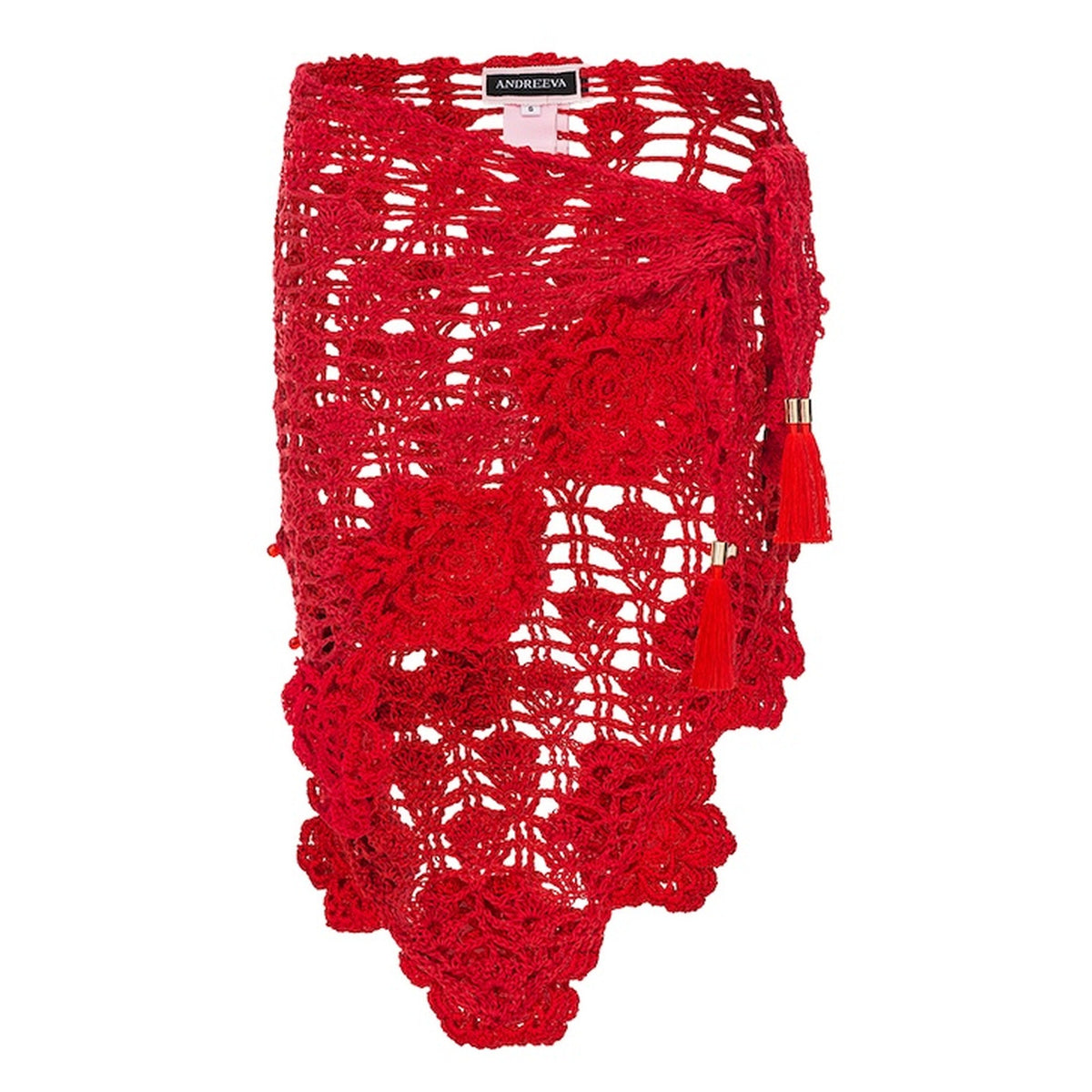 The ANDREEVA Cherry Handmade Crochet Cover-Up is a vibrant red wrap skirt featuring an asymmetrical hem, floral crochet patterns, tassel accents, and a visible label sewn inside the waistband, showcasing artisanal craftsmanship.