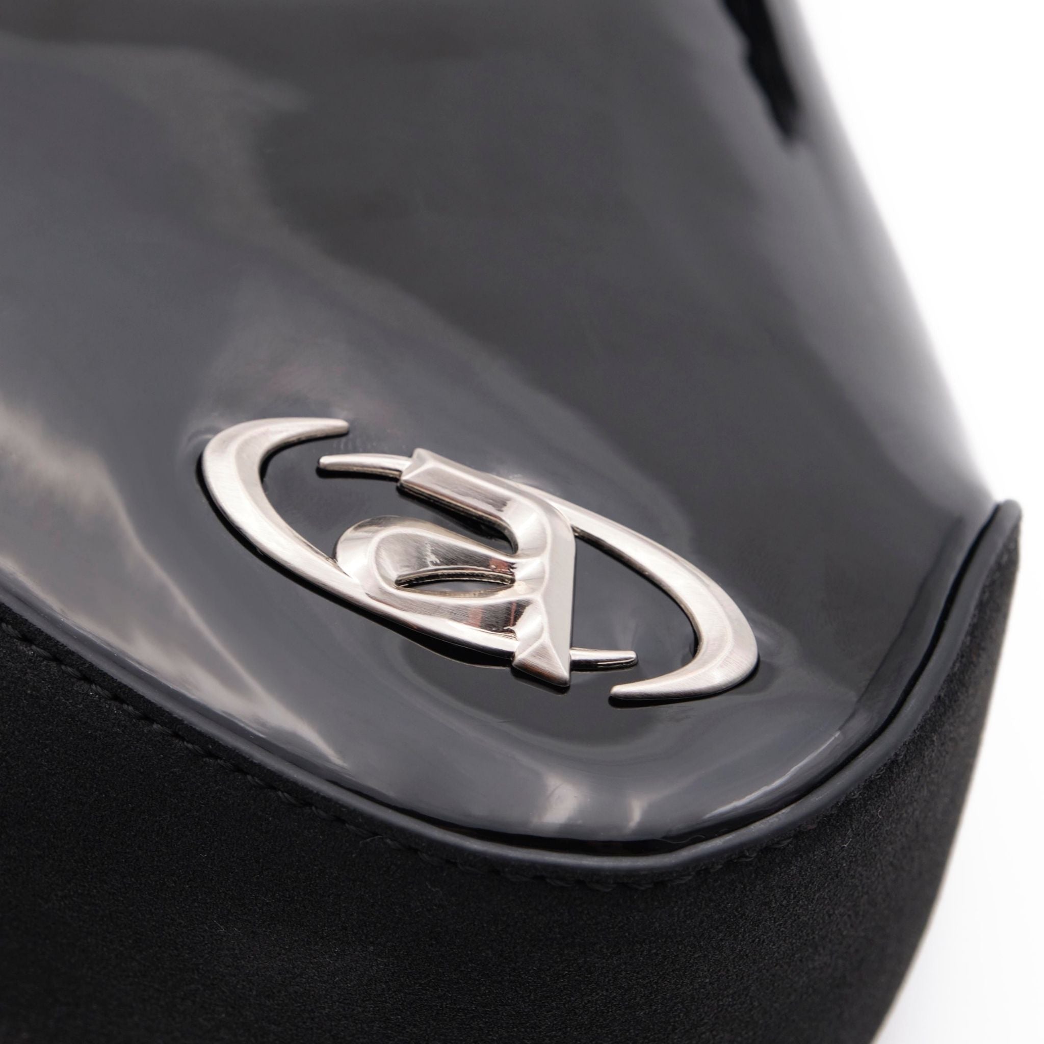 Close-up of a car emblem on a black vehicle.