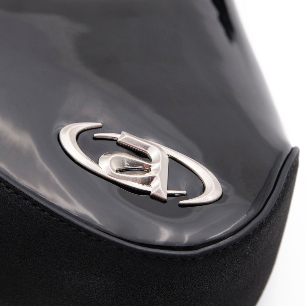 Close-up of a car emblem on a black vehicle.