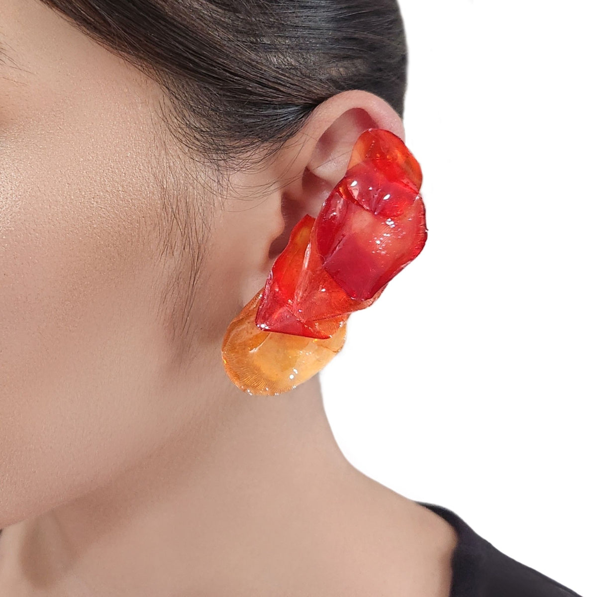 Model ear wearing earrings  in close showing both ears 
