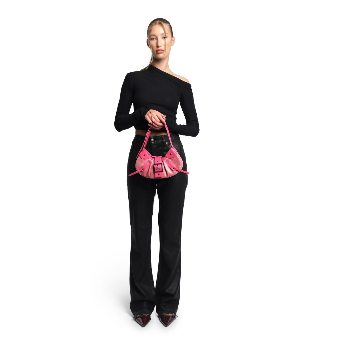 Woman holding a pink handbag against a white background