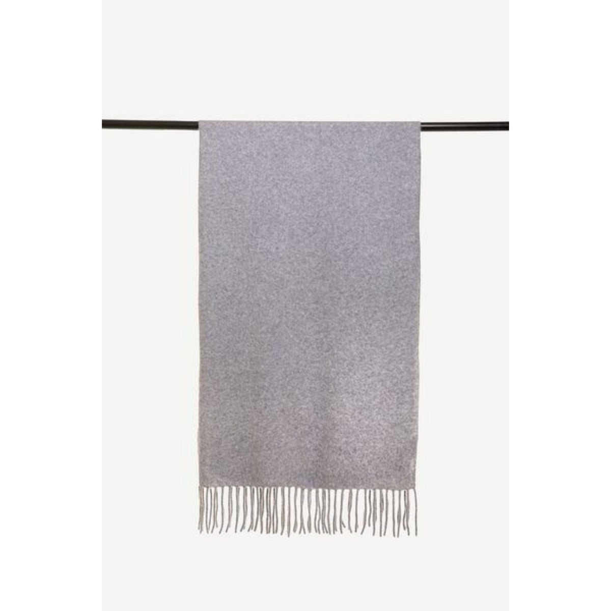 The OO-TO Grey Knitted Felted Cashmere Chunky Scarf, in light gray with a soft texture, is draped over a black rod and features a simple design with short, thin fringe on the bottom edge.