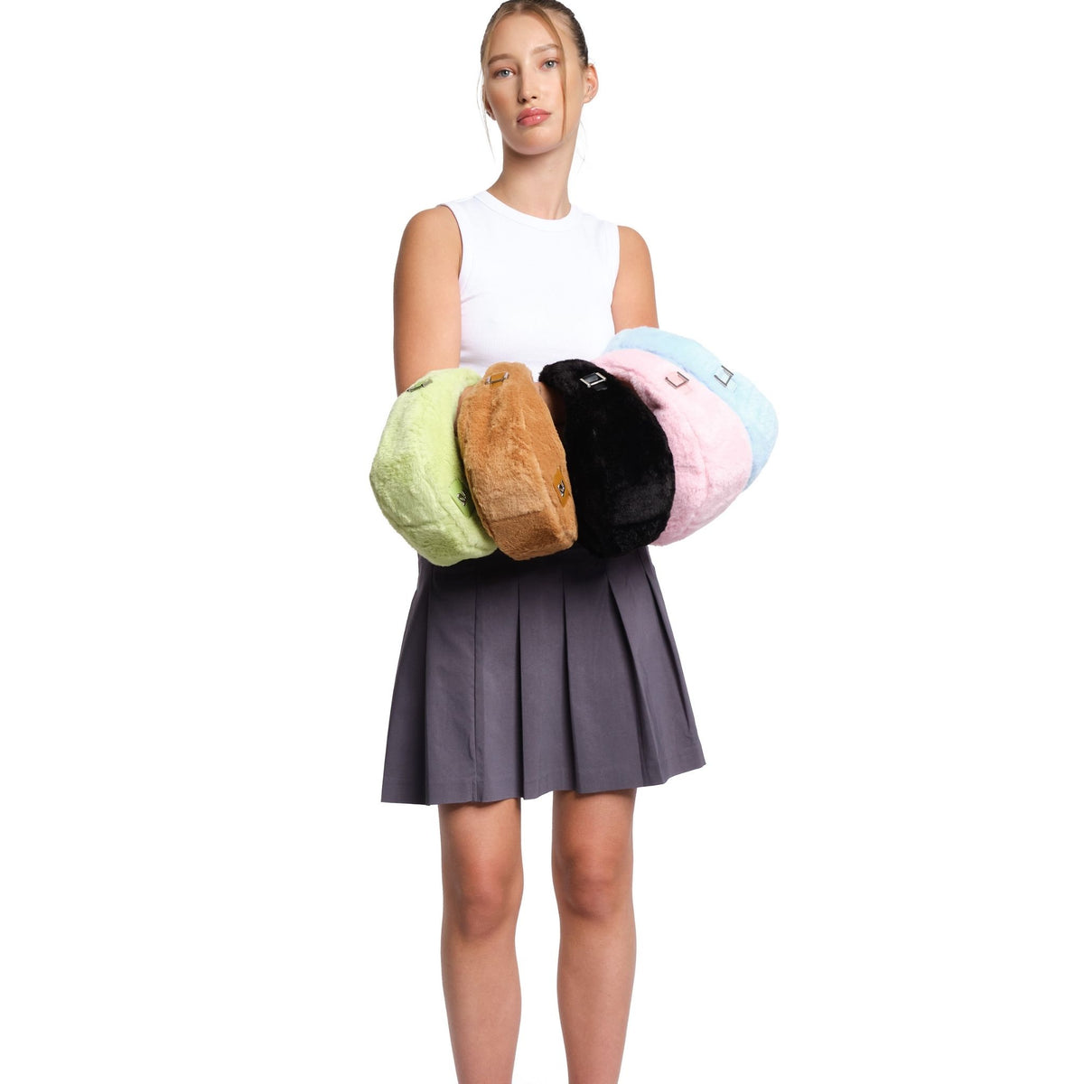 Woman holding four colorful cushions against a white background