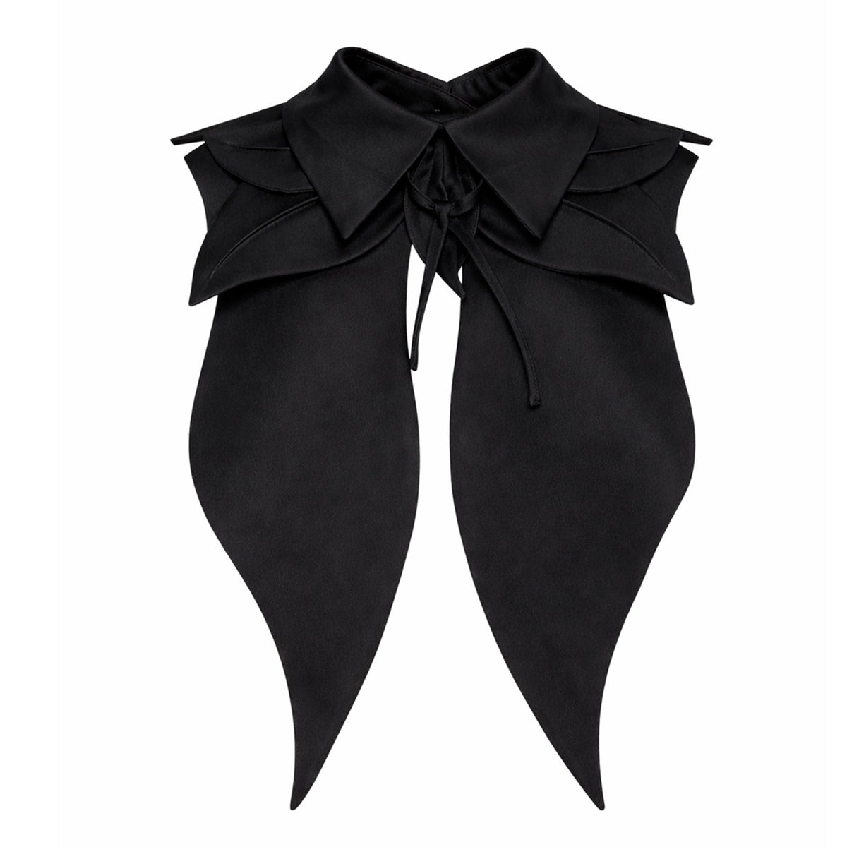 The Oversized Satin Bib Collar in black by JULIA ALLERT features layered, pointed edges and long panels tied at the front—a sculptural statement piece shown strikingly against a white background.